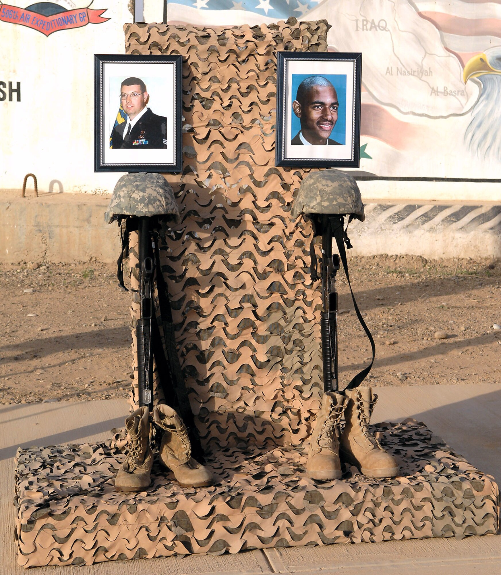 Members of the 727th Expeditionary Air Control Squadron set up a memorial in remembrance of two of the unit's fallen Airmen during a ceremony to commemorate the fifth anniversary of Operation Iraqi Freedom March 20 at Kirkuk Air Base, Iraq. Staff Sgt. Patrick Griffin and Airman 1st Class Antoine Holt, both from the 727th EACS, died during combat operations in 2003 and 2004. (U.S. Air Force photo/Senior Airman SerMae Lampkin) 
