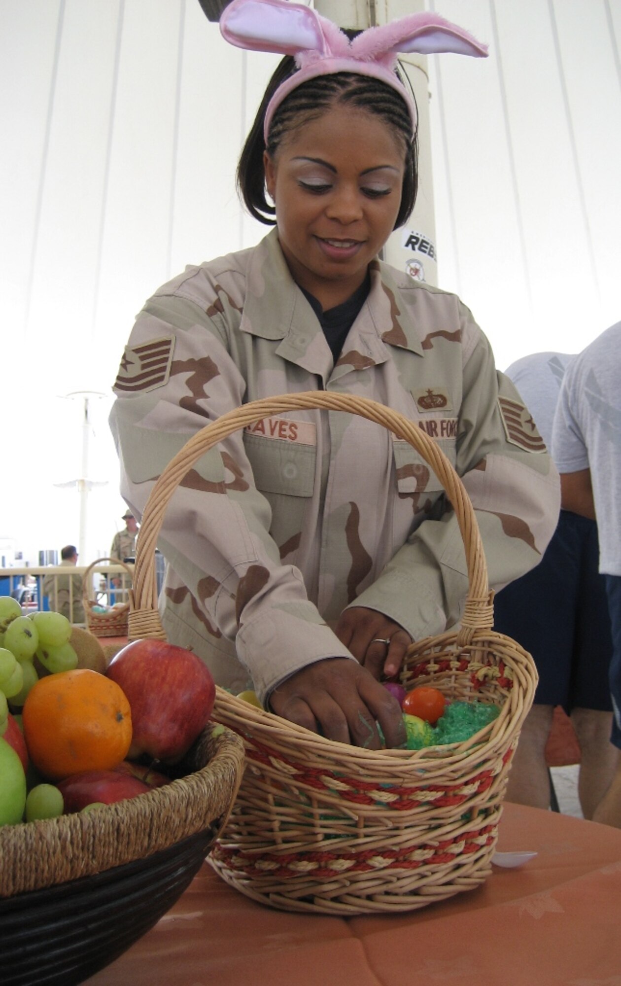 379th Expeditionary Services Squadron flight kitchen manager Tech. Sgt. Tanja Graves prepares Easter goodies for the holiday brunch that was held in memorial plaza Sunday.  The 379th ESVS hosted the event that allowed service members to celebrate the holiday with a special meal. (U.S. Air Force photo/2nd Lt. Tania Bryan)