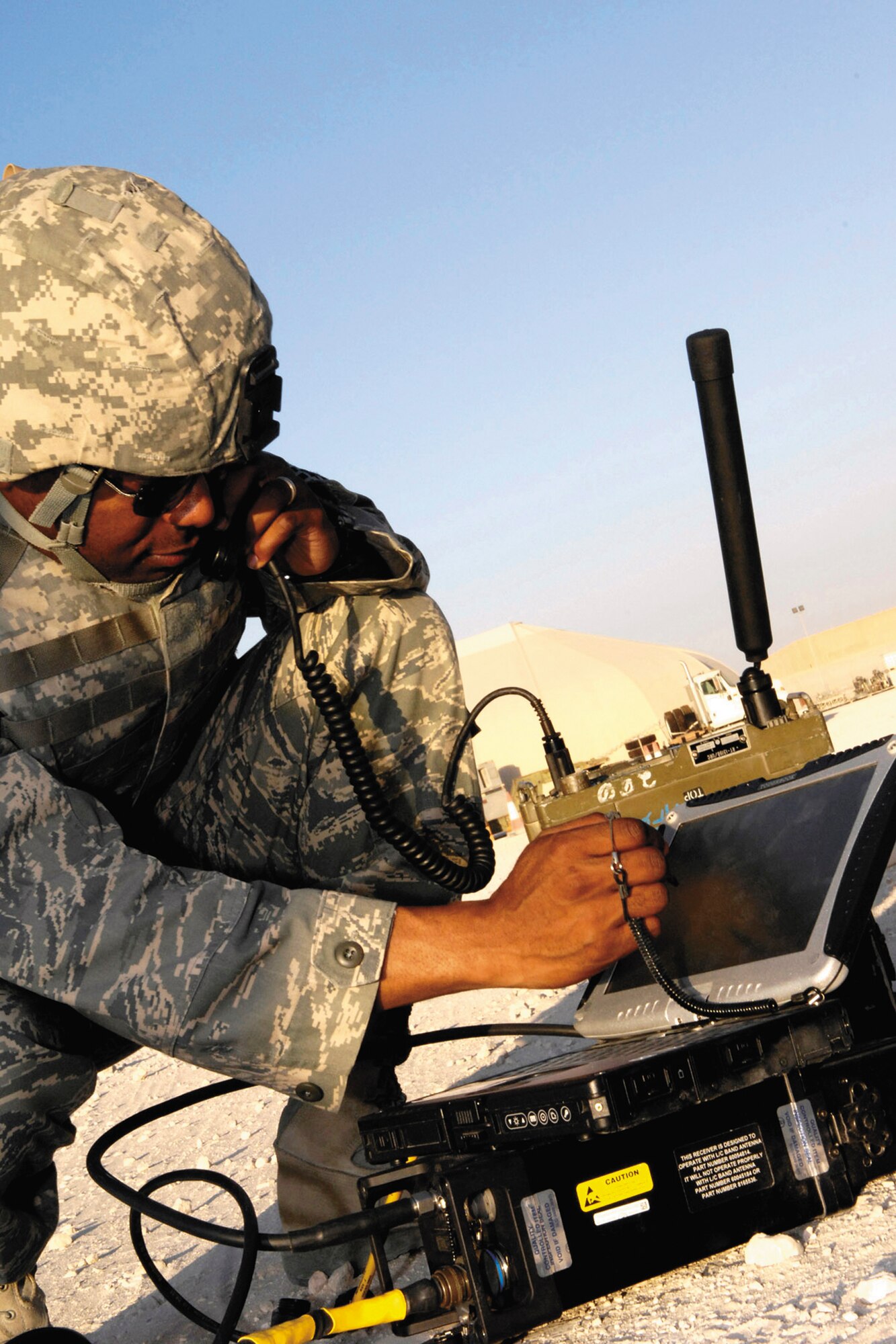 Joint terminal attack controller Master Sgt. Chris Thompson communicates via a remotely operated video enhanced receiver recently in Southwest Asia. The ROVER, a small laptop with an external antenna, allows the JTAC to see from the eyes of the pilot, ensuring minimal collateral damage. (Staff Sgt. Angelique Perez)