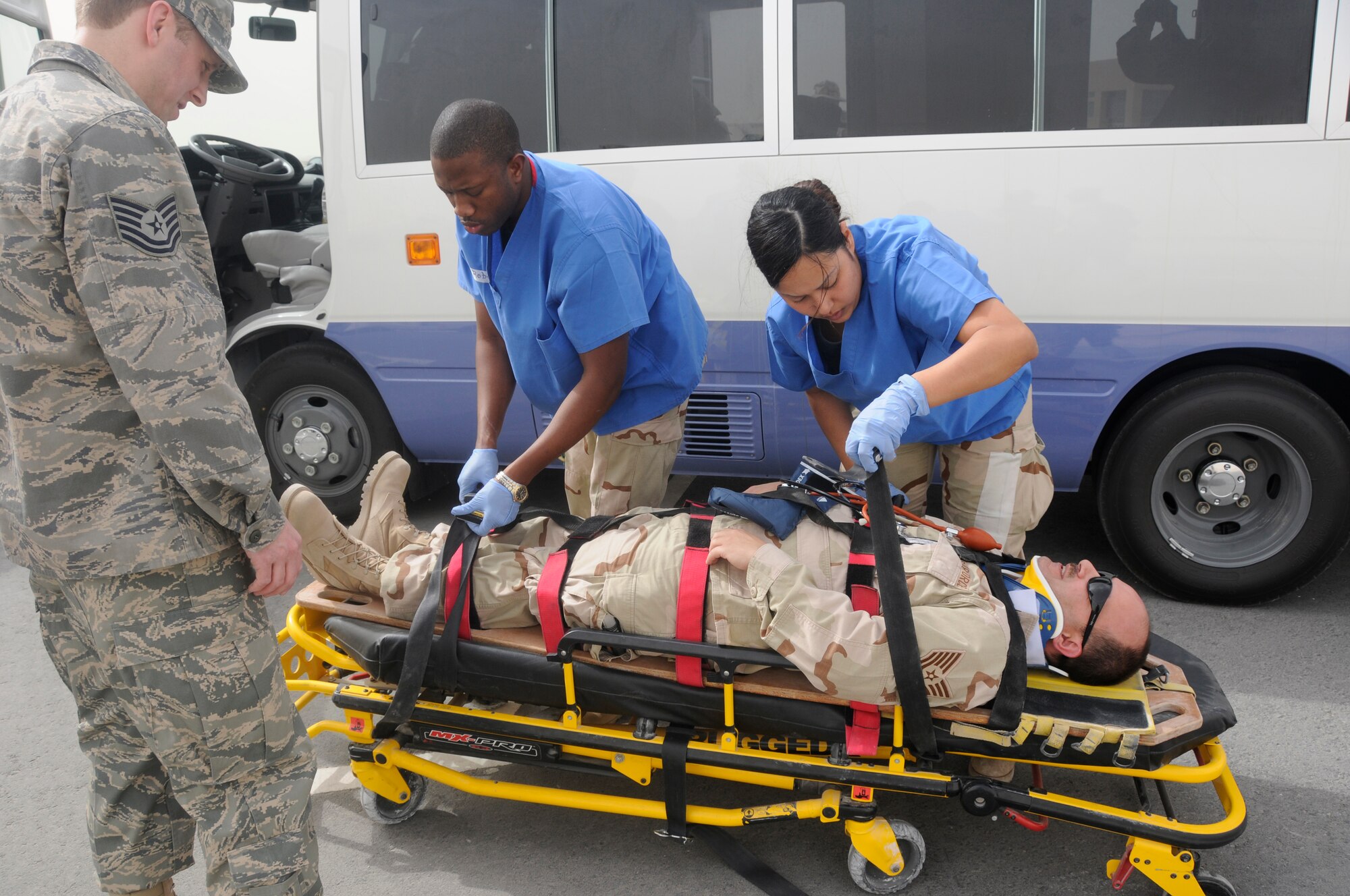 Members of the 379th Expeditionary Medical Group respond to a simulated bus accident during a Major Accident Response Exercise here March 20. (U.S. Air Force photo/ Senior Airman Domonique Simmons.)