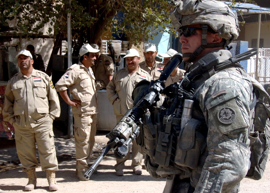U.S. Army Sgt. Difruscio provides security as a new Sons of Iraq checkpoint is established in the Rashid district of Baghdad, Iraq, March 6, 2008. Difruscio is assigned to the 1st Infantry Division's 2nd Squadron, 2nd Stryker Cavalry Regiment.  The Sons of Iraq is a group of concerned local citizens participating in efforts to improve security in Iraq.