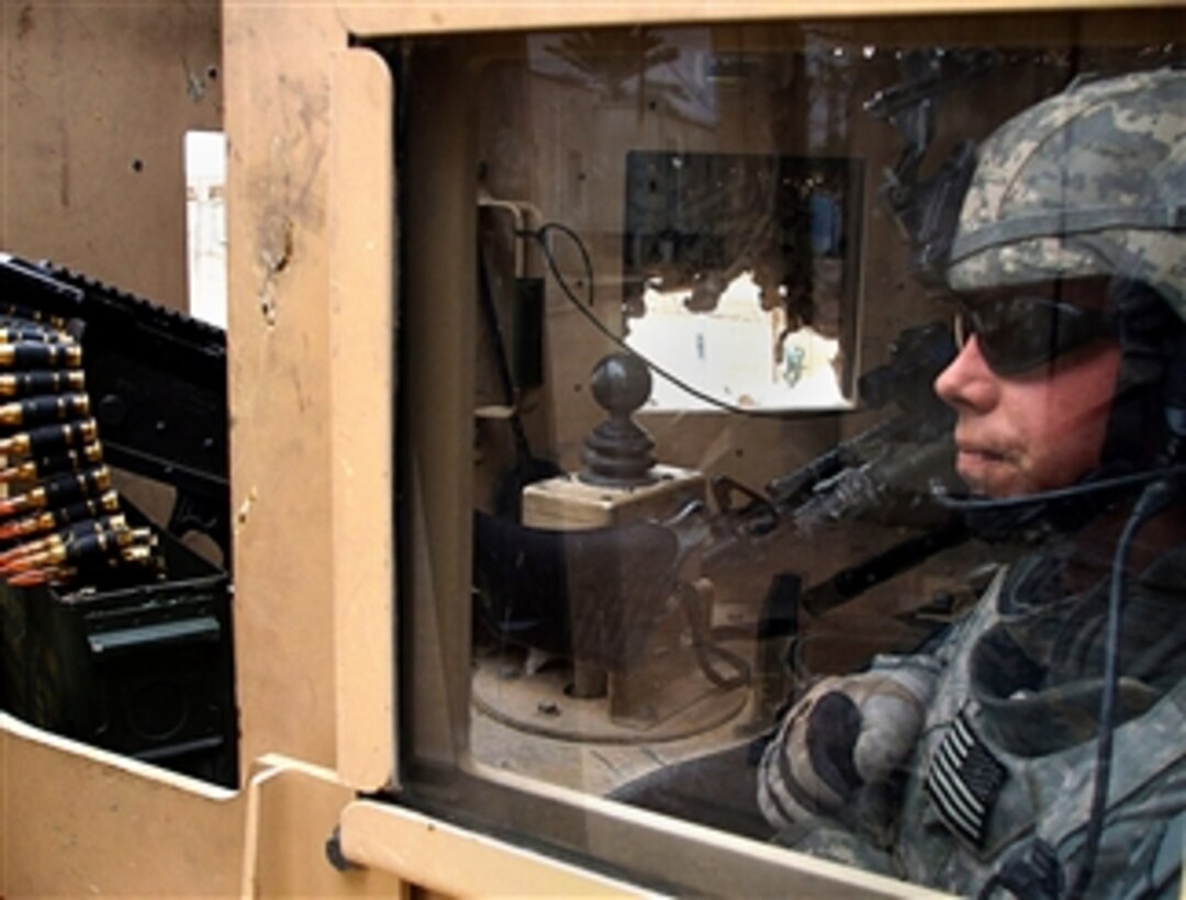 A U.S. Army soldier  sits in the gunner's hatch of a U.S. Army vehicle during a patrol in Musayyib, Iraq, March 11, 2008. The soldier is assigned to the 3rd Infantry Division's 4th Brigade Combat Team.