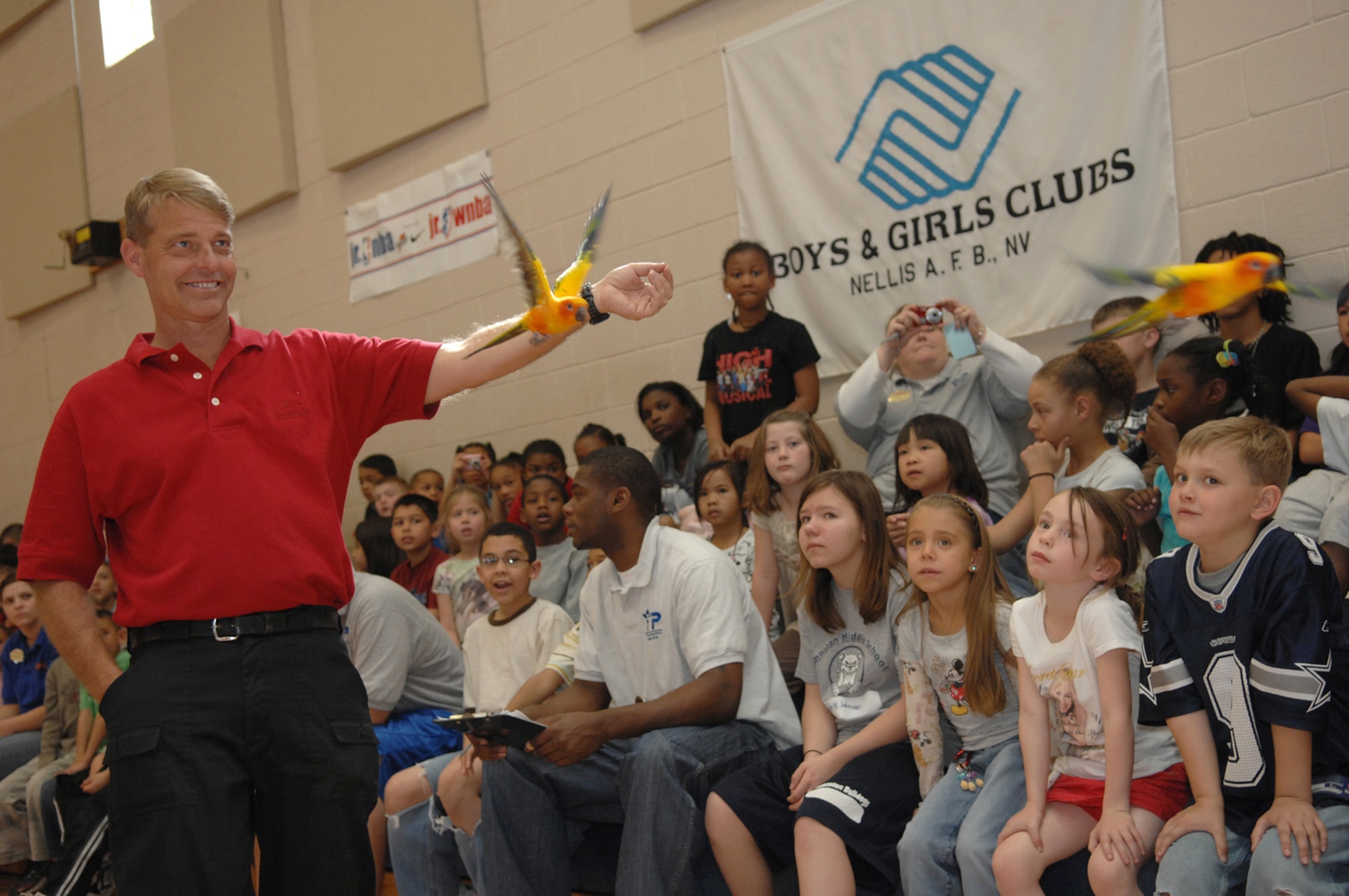 Mr. Gary Faucher, a SeaWorld Animal Ambassador Team member, displays the Sun Conure, a South American Parrot during a SeaWorld animal showcase at the Youth Center March 20, 2008 Nellis Air Force Base, Nev.
(U.S. Air Force Photo by/Senior Airman Larry E. Reid Jr.)