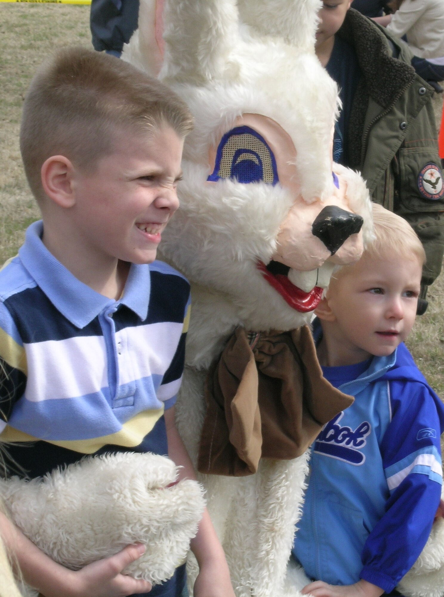 Caleb, 6, and Colby Gibbs, 2, smile with the Easter Bunny during the base wide Easter Egg Hunt March 22. The children are the kids of Maj. Darin Gibbs, 71st Logistics Readiness Squadron commander, and his wife Tina. (Air Force photo by Melissa Seror)
