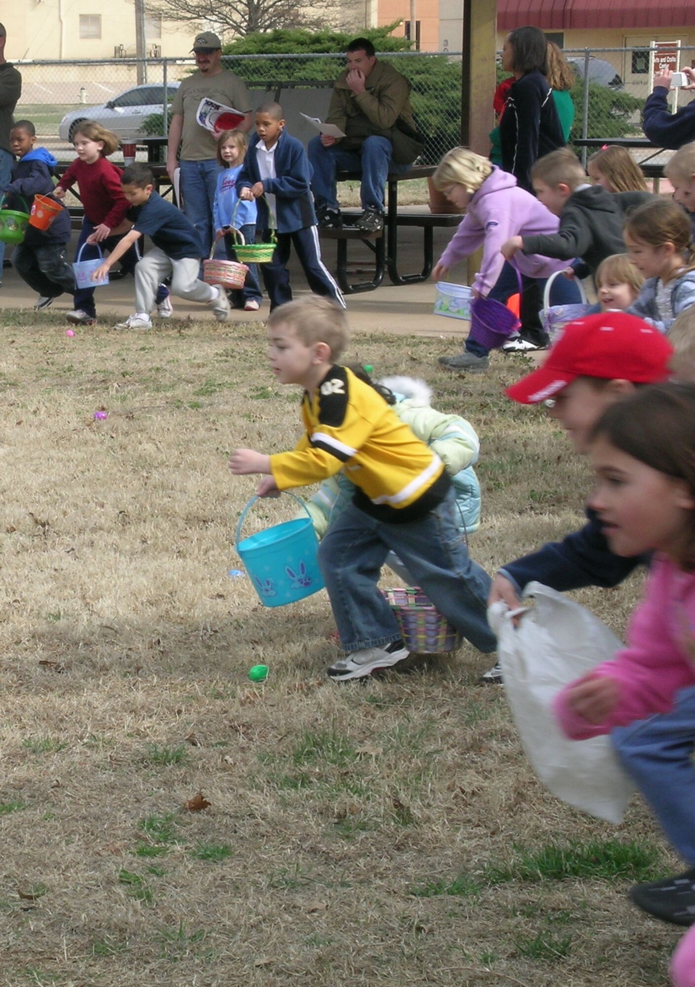 Children ages six to nine years old take off in search of Easter eggs during the base wide Easter Egg Hunt on March 22. (Air Force photo by Melissa Seror)
