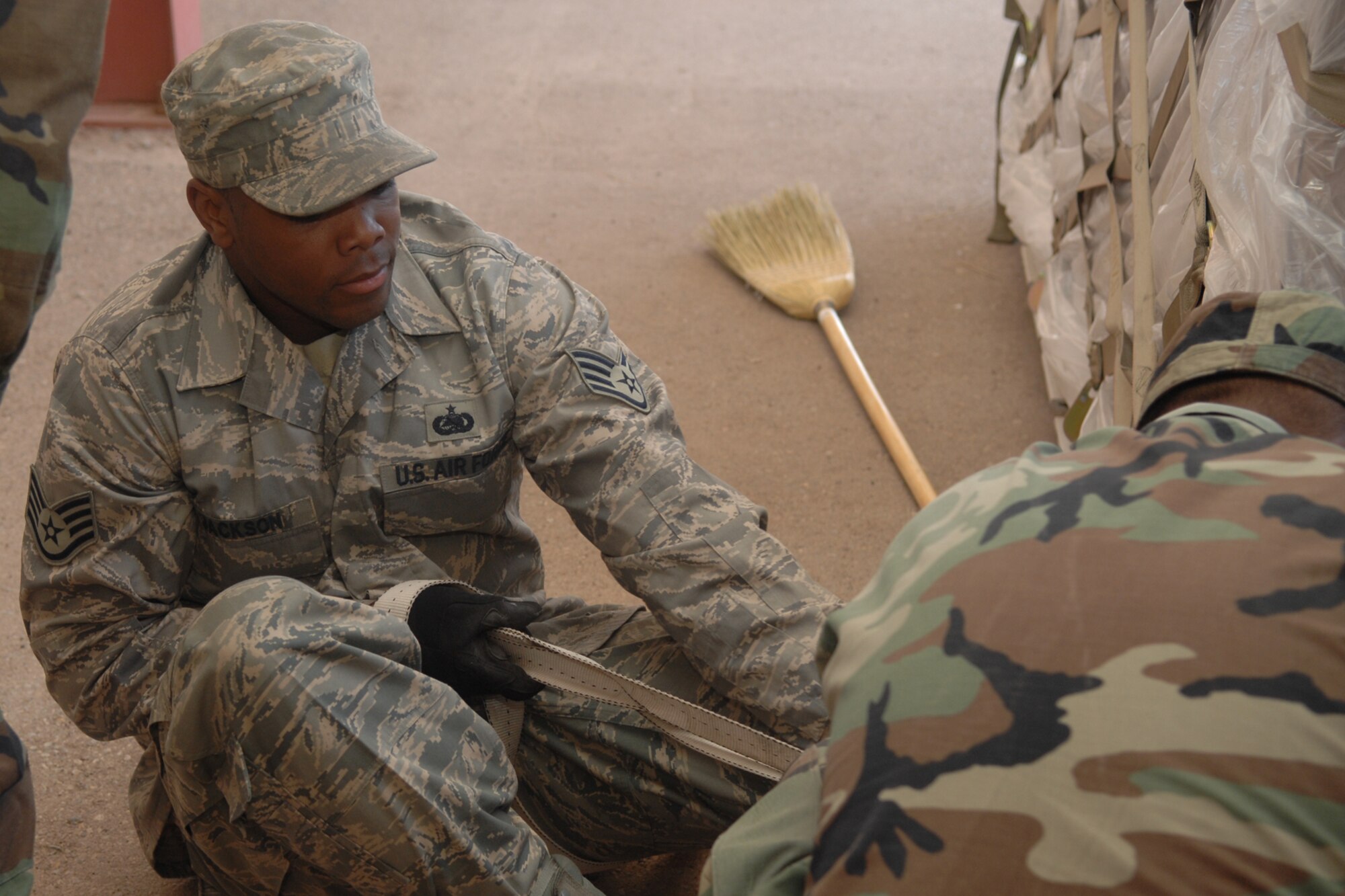 Staff Sgt. Nathaniel Jackson, 49th Materiel Maintenance Support Squadron, straps a pallet of air conditioners and heaters on Holloman Air Force Base, N.M., March 24. This unit, along with many others, is preparing for a simulated deployment as part of an upcoming base-wide exercise. (U.S. Air Force photo/Airman Sondra M. Wieseler)