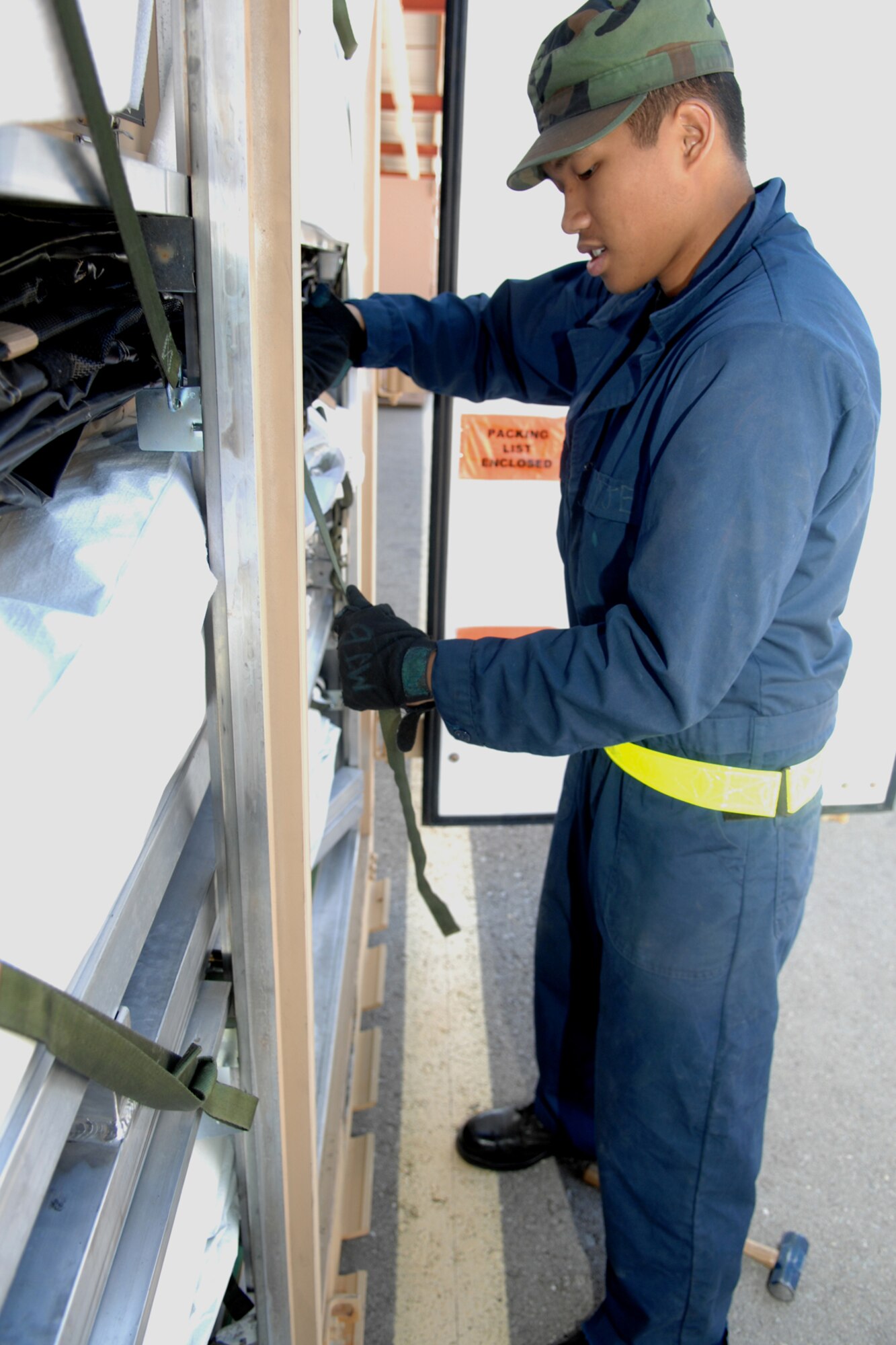Airman Marques Barcelona, 49th Materiel Maintenance Support Squadron, straps the components in a container being prepared for deployment on Holloman Air Force Base, N.M., March 24. Airman Barcelona, along with many other Airmen from 49 MMSS, is preparing units for the upcoming base-wide operational readiness excersie. (U.S. Air Force photo/Airman Sondra M. Wieseler)