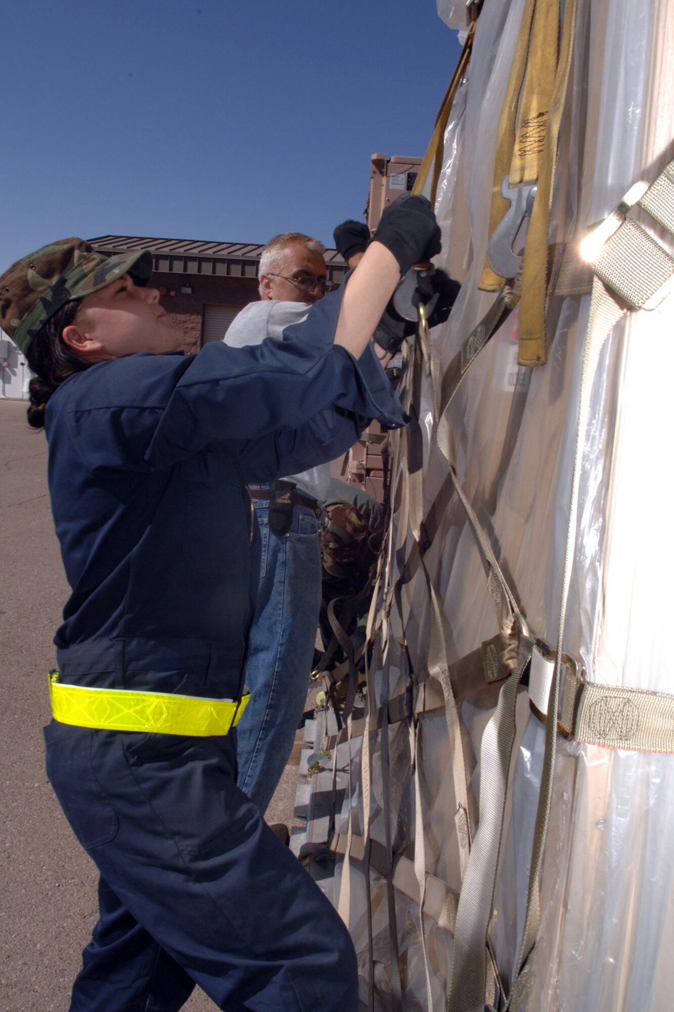 Airman Tera Russo, 49th Materiel Maintenance Support Squadron, helps strap a kit of electric cargo March 24 on Holloman Air Force Base, N.M. The unit is preparing for a simulated deployment for an upcoming operational readiness exercise. (U.S. Air Force photo/Airman Sondra M. Wieseler)