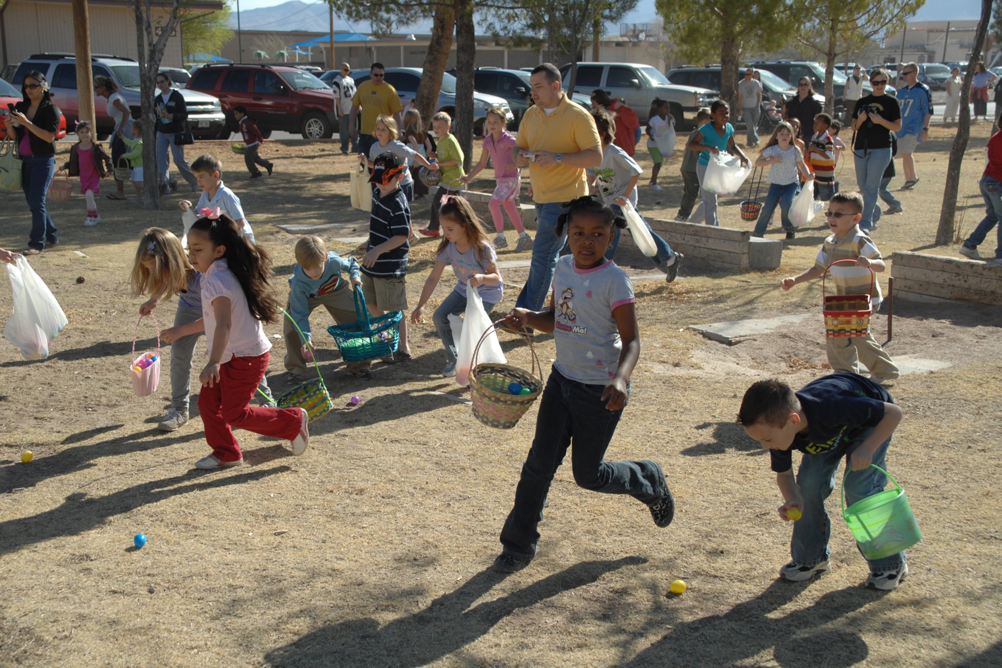 Children rush the fields of Steinhoff Park to retrieve Easter eggs during the Base Wide Easter Egg Hunt March 22 at Holloman Air Force Base, N.M. More than 800 children and 1,500 parents and grandparents showed to take part in the event. (U.S. Air Force photo/Airman 1st Class Jamal D. Sutter)