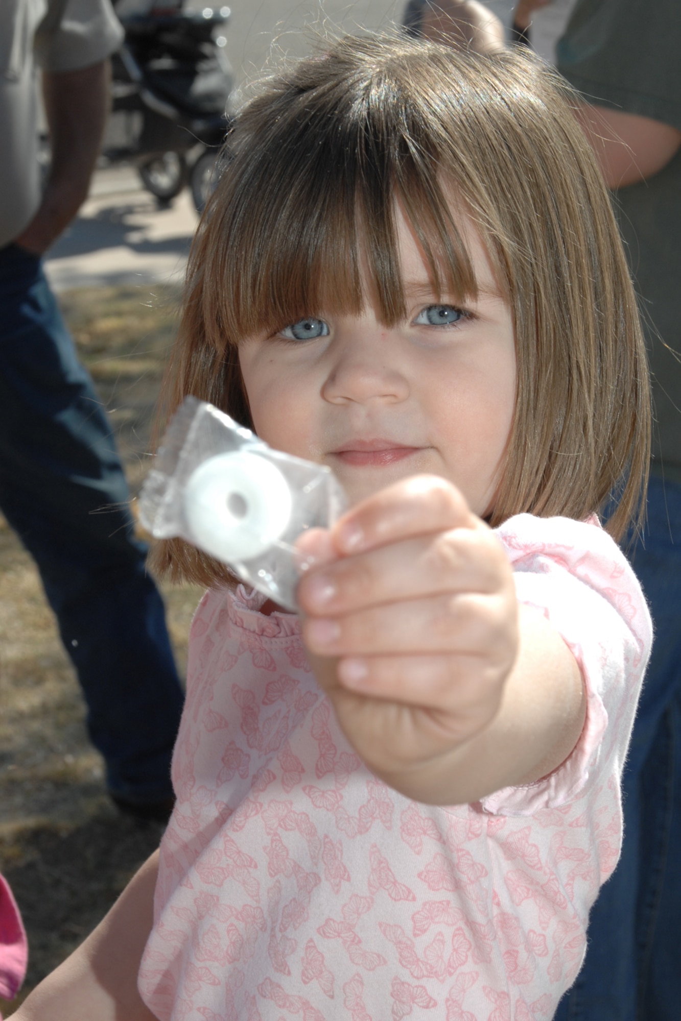 Destyn Neely, 3, shares a treat during the Base Wide Easter Egg Hunt March 22 at Holloman Air Force Base, N.M. Destyn is the daughter of Tech. Sgt. Dustyn Neely, 49th Maintenance Squadron. (U.S. Air Force photo/Airman 1st Class Jamal D. Sutter)