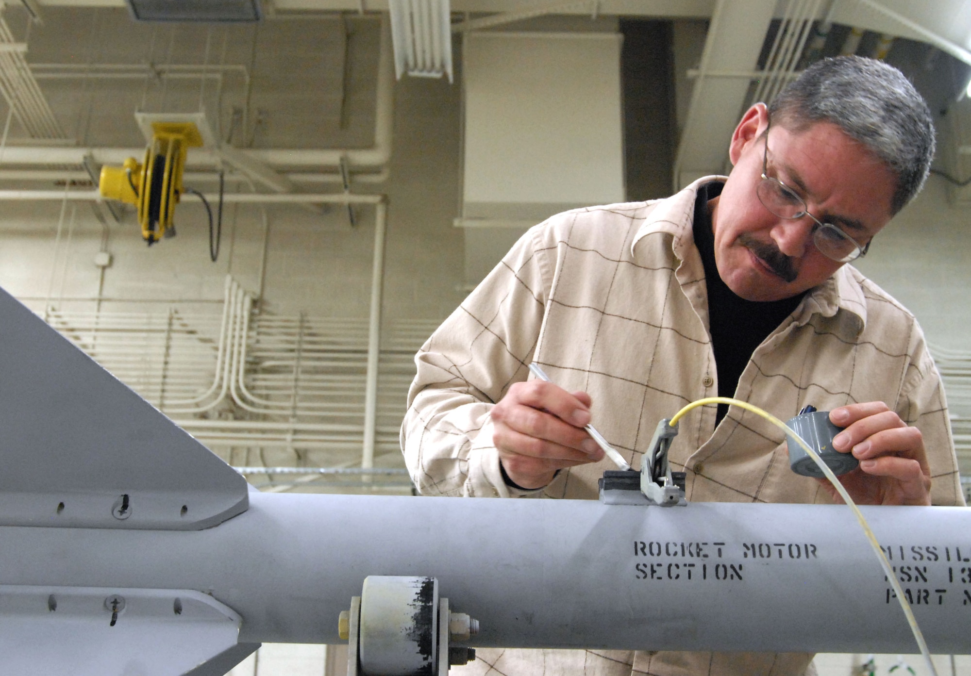 Shawn Cotey, 412th Maintenance Squadron munitions maintenance mechanic, is the Air Force Flight Test Center Trades and Labor Civilian of the Year. Among his accomplishments during the year, Mr. Cotey tackled the building of 27 BDU-50s, four GBU-39s and four CBU-105s for the B-1B Lancer. He also built and processed approximately 2,100 chaff and flare countermeasure munitions for the F-22 Raptor. (Air Force photo by Senior Airman Stacy Sanchez)