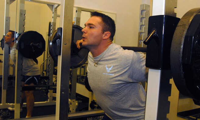 VANDENBERG AIR FORCE BASE, Calif., --  2nd Lt. Michael Tuchscherer, a student at the 392nd Training Squadron warms up before starting his power lifting work out at the base gym on Mar. 3. Tuchscherer took first place in the Quest American Invitational Arnold Classic Power Lifting Competition this past weekend in his weight of 275 lbs. (U.S. Air Force photo / SrA Christopher Hubenthal)
