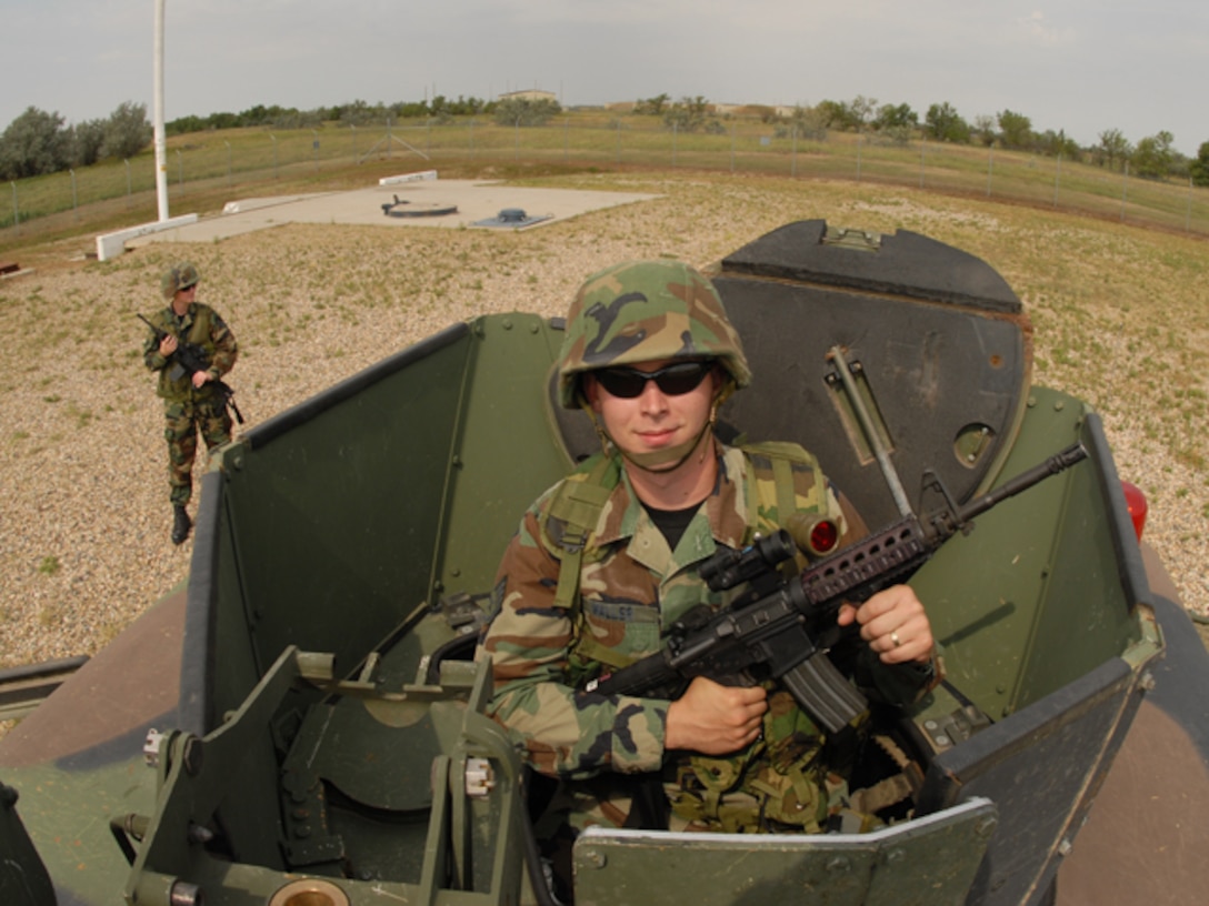 U.S. Air Force Staff Sgt. Martin L. Waller, foreground, and Senior Airman Jennifer M. Goulet, both of the 119th Security Forces Squadron, take a defensive posture during  a simulated intruder exercise at a missile field security forces training site at the Minot Air Force Base, Minot, N.D. Aug.3.   (U.S. Air Force photo by Senior Master Sgt. David H. Lipp) (Released)
