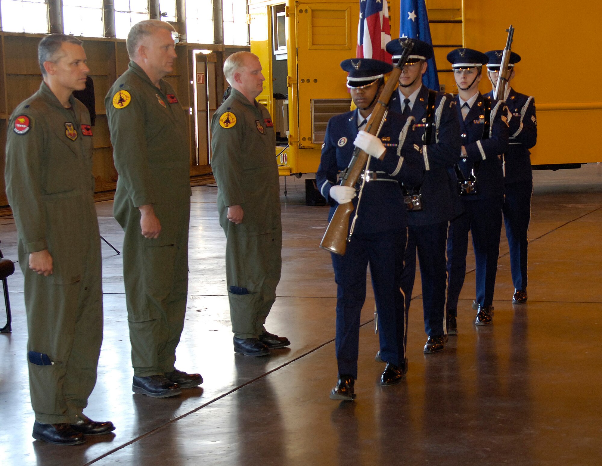 Lt. Col. James Lee, 82nd Aerial Targets Squadron commander, Lt. Col. Joel Rush, Det 1 82nd ATRS outgoing commander and Lt. Col. Ryan Luchsinger, incoming commander, stand at attention as the Holloman Air Force Base, N.M., "Steel Talons" honor guard present the colors during the change of command ceremony March 21.  Courtesy photo. 