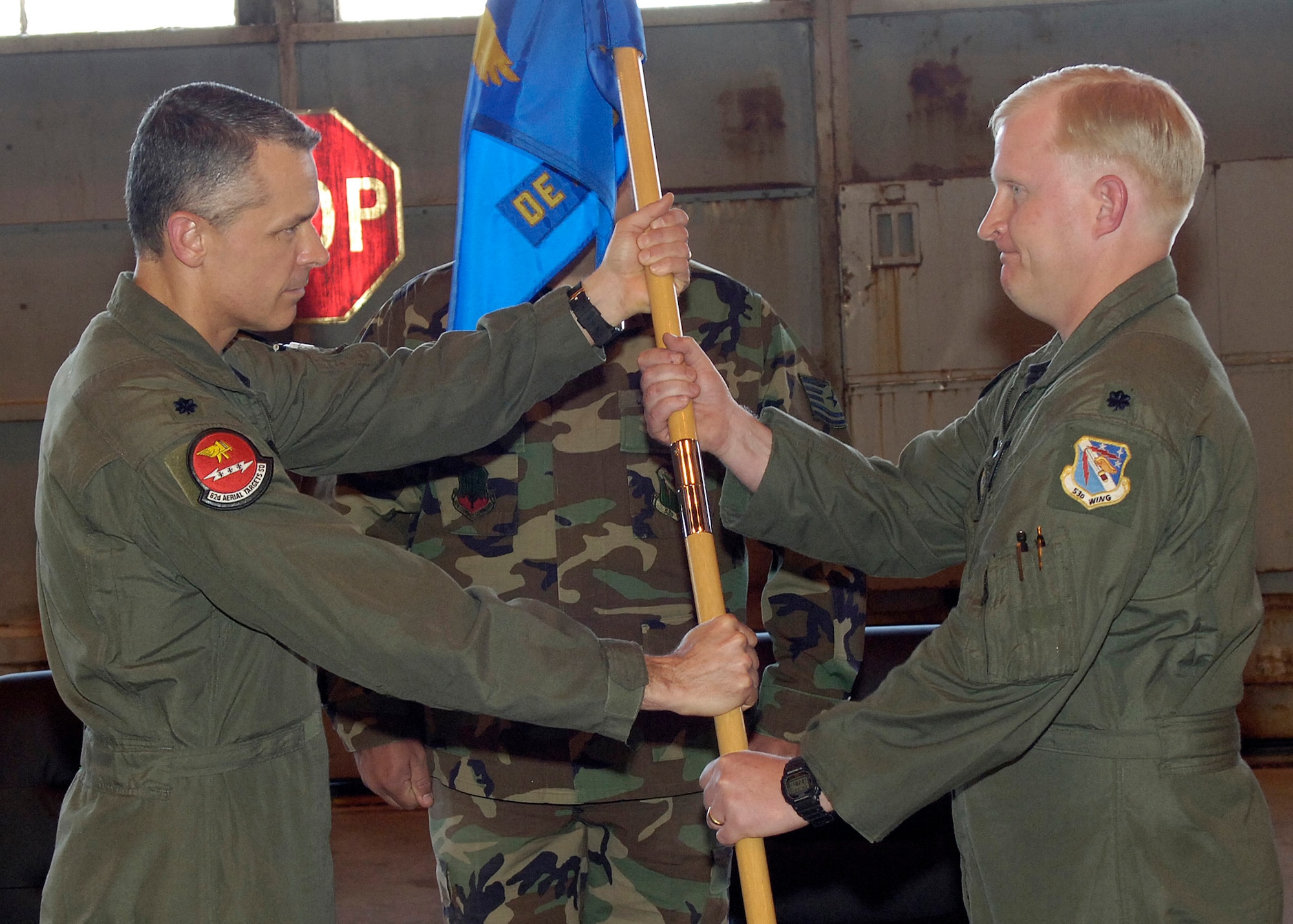 Lt. Col. James Lee, 82nd Aerial Targets Squadron, passes Detachment 1's guidon to its new commander, Lt. Col. Ryan Luchsinger at a ceremony at Holloman Air Force Base, N.M., March 21.  Colonel Luchsinger assumed command from Lt. Col. Joel Rush.  Courtesy photo. 