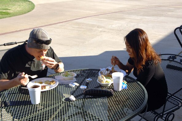 BARKSDALE AIR FORCE BASE, La. -- The 2d Logistics Readiness Squadron's 1st Lt. Daniel Gregorich and 2nd Lt. Lia Amilia-Weston enjoy a steak dinner at Barksdale's Fox Run Golf Course "cook your own steak" night. Each plate comes with meat, a salad, a roll, a baked potato and a soft drink. Hot dog plates are available for children. (U.S. Air Force photo by Staff Sgt. Mike Andriacco) 