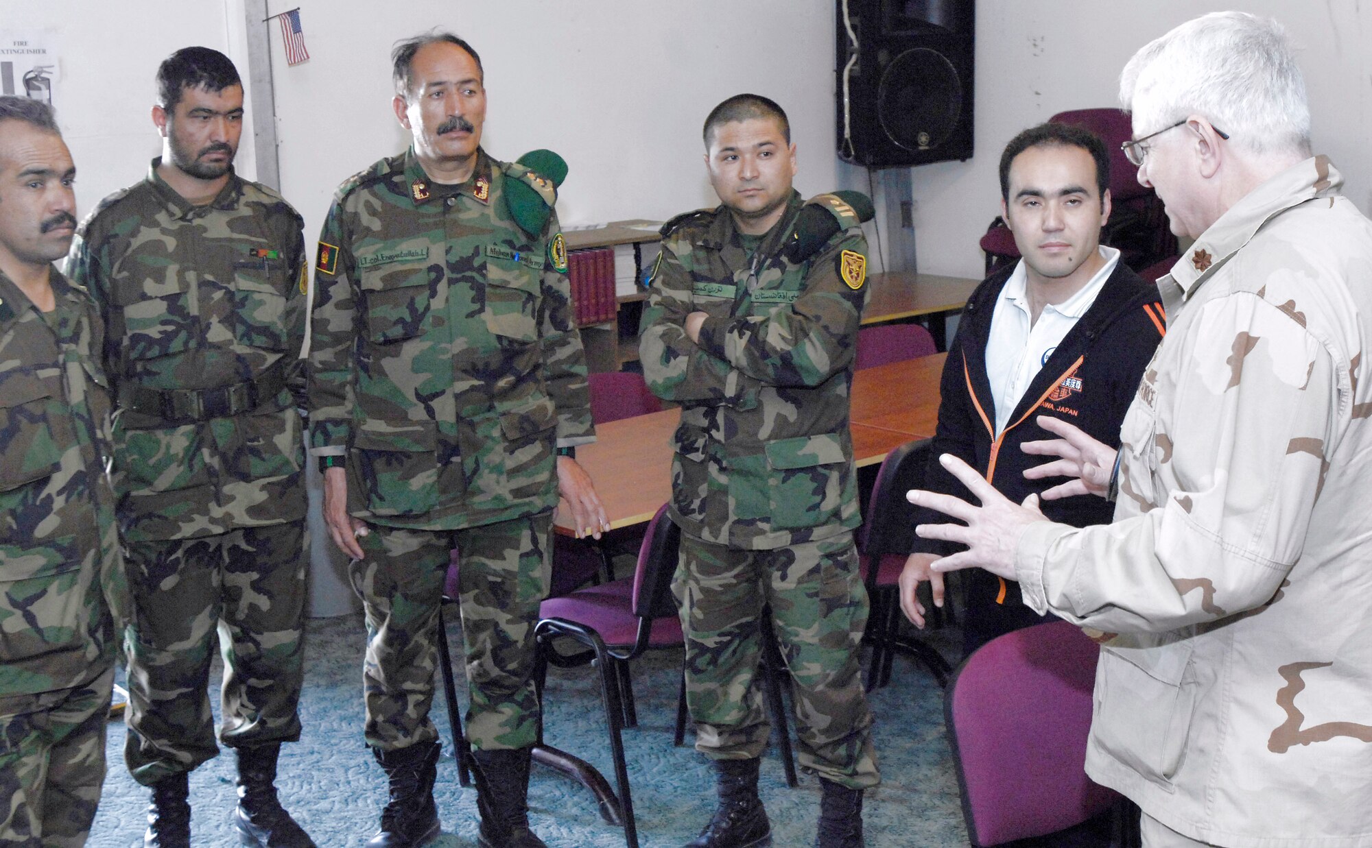 Commanders from the Afghan national army are briefed by Chaplain (Maj.) William Bartoul (far right) March 24 at Manas Air Base, Kyrgyzstan. The Afghan commanders, who are transiting Manas AB on their way back from training in Germany, asked for a tour of the facility. Chaplain Bartoul briefed the commanders on the variety of worship available at the base and how base chaplains help facilitate servicemembers of all religions to practice their faith. Chaplain Bartoul is assigned to the 376th Air Expeditionary Wing. (U.S. Air Force/Senior Airman Tabitha Kuykendall)