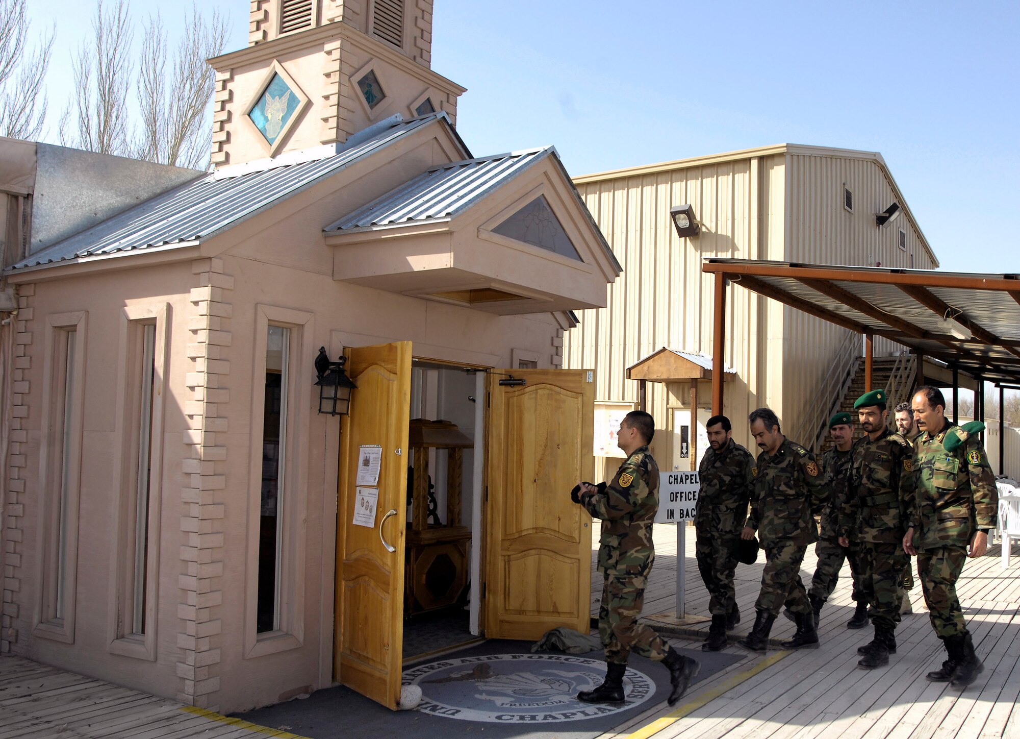 Afghan commanders tour the base chapel March 24 at Manas Air Base, Kyrgyzstan. The Afghan leaders are transiting Manas AB on their way back from training in Germany and asked for a tour of the chapel. Chaplain (Maj.) William Bartoul of the 376th Air Expeditionary Wing briefed the commanders on the variety of worship available at the base and how base chaplains help facilitate servicemembers of all religions to practice their faith. (U.S. Air Force photo/Senior Airman Tabitha Kuykendall) 