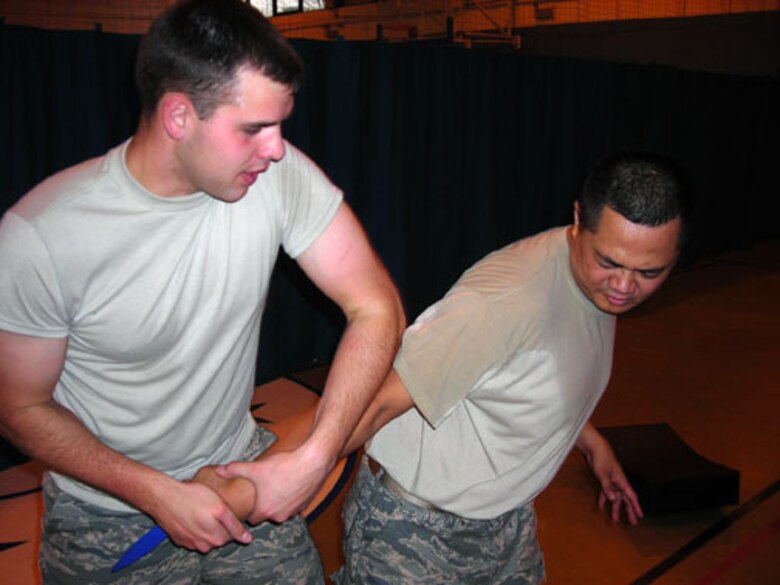 Airman 1st Class Stephen Ardary and Senior Airman Melquiadez Racho practice a Krav Maga move learned during recent training at RAF Mildenhall. Krav Maga is the official self-defense system of the Isreali Defense Forces. The Airmen are assigned to the 423rd Security Forces Squadron at RAF Alconbury and are two of 12 Airmen on Alconbury to receive the training.  