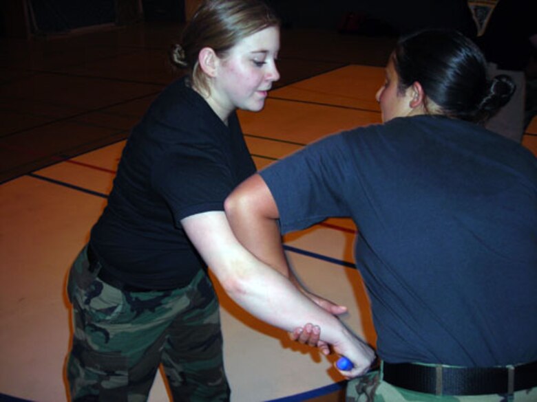 Staff Sgt. Leif Gisselberg and Senior Airman Brian Jones practice a Krav Maga move learned during recent training at RAF Mildenhall. Krav Maga is the official self-defense system of the Isreali Defense Forces. Sergeant Gisselberg and Airman Jones are assigned to the 423rd Security Forces Squadron at RAF Alconbury and are two of 12 Airmen on Alconbury to receive the training.  