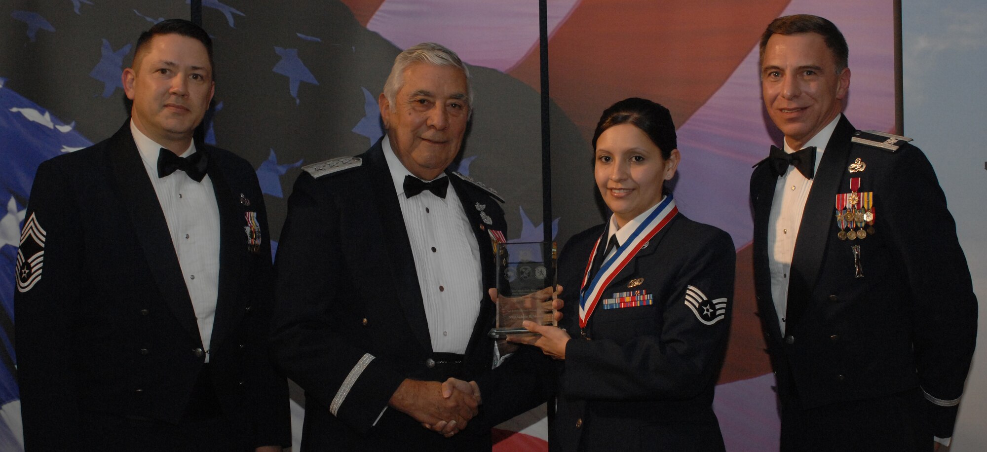 Information and Communications NCO 
(from left) Chief Master Sgt. Gregory Blue, 100th Maintenance Group chief enlisted manager; Lt. Gen. Leo Marquez; Staff Sgt. Valerie Moore, 100th Maintenance Operations Squadron and award recipient; and Col. Michael Seville, 100th Maintenance Group commander. (U.S. Air Force photo by Airman 1st Class Brad Smith)
