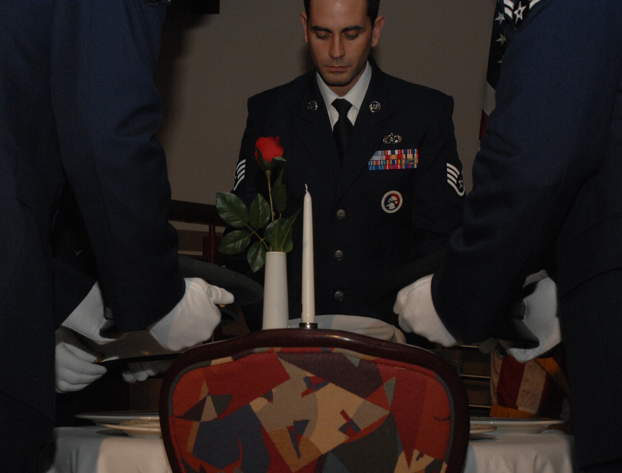 Staff Sgt. Justin Daly, 100th Aircraft Maintenance Squadron, honors fallen servicemembers from each of Air Force's sister services during RAF Mildenhall's Kuncklebuster Awards March 22. Sergeant Daly served as the NCO in charge of the event's honor guard, which was comrpised of Airmen with the 100th Maintenance Group. For more photos from the event, click on "View all images" below the photo. (U.S. Air Forec photo by Airman 1st Class Brad Smith)