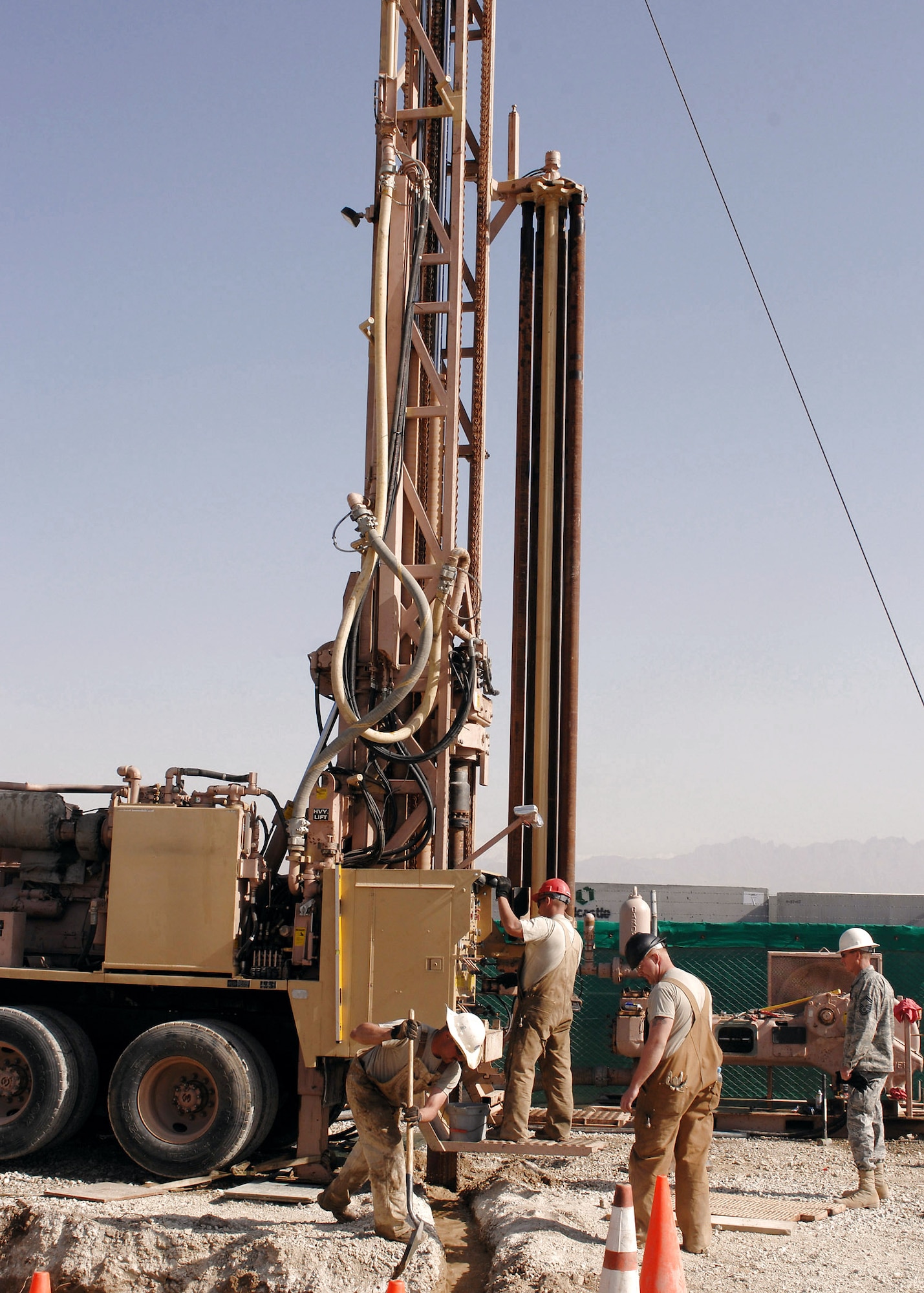 Airmen from the 819th RED HORSE Squadron drill a test hole to operationally check a water-well digging rig March 21 at Bagram Air Base, Afghanistan. More than $400,000 of damage to the rig was repaired at a cost of $80. (U.S. Air Force photo/Master Sgt. Demetrius Lester) 
