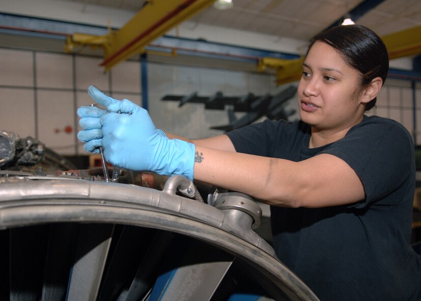 DYESS AIR FORCE BASE, Texas -- Staff Sergeant Jerusha Johnson  loosens nuts on a B-1 engine during an engine disassembly at the engine test center Mar. 24. The bolts hold the outer part of the fan together to allow the engines fan blades to rotate properly. (U.S. Air Force Photo by Airman 1st Class Micheal Breaux)