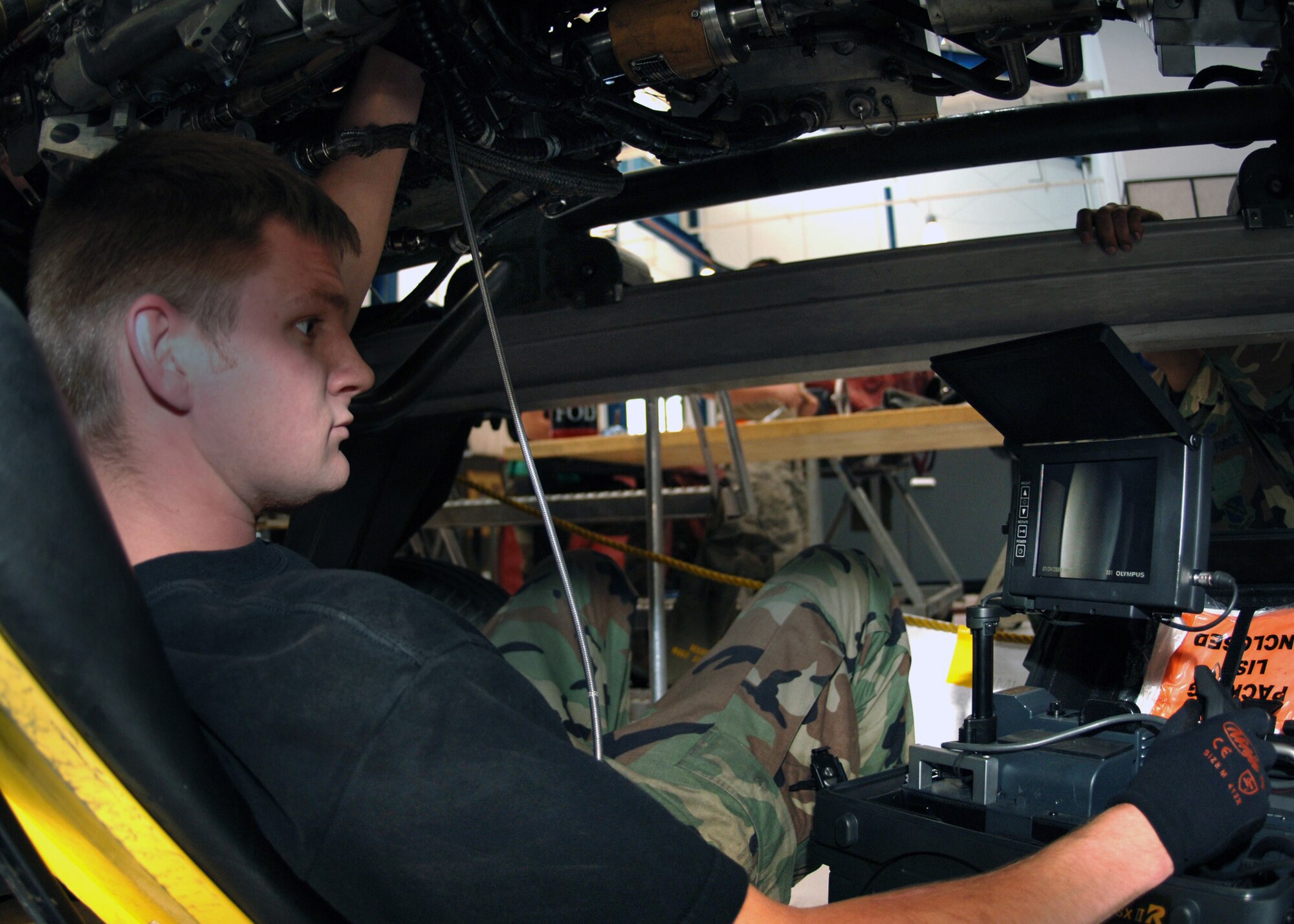DYESS AIR FORCE BASE, Texas -- Senior Airman Jack Ruen watches a monitor that is connected to a borescope inside of a B-1 engine, Mar. 24. The Borescope is a cable fed camera that is directed into the turbines of an engine and allows the user to view the turbines on a monitor display. (U.S. Air Force Photo by Airman 1st Class Micheal Breaux)