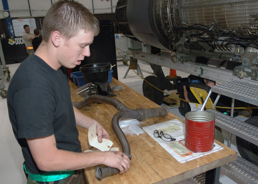 DYESS AIR FORCE BASE, Texas -- Airman 1st Class A.J. Carden uses a AFTO form 350 to identify an Anti-Ice Manifold during an engine disassembly, Mar. 24. The process of using a AFTO form 350 is also known as tagging parts and is primarily used to identify different parts of a unassembled engine. (U.S. Air Force Photo by Airman 1st Class Micheal Breaux) 