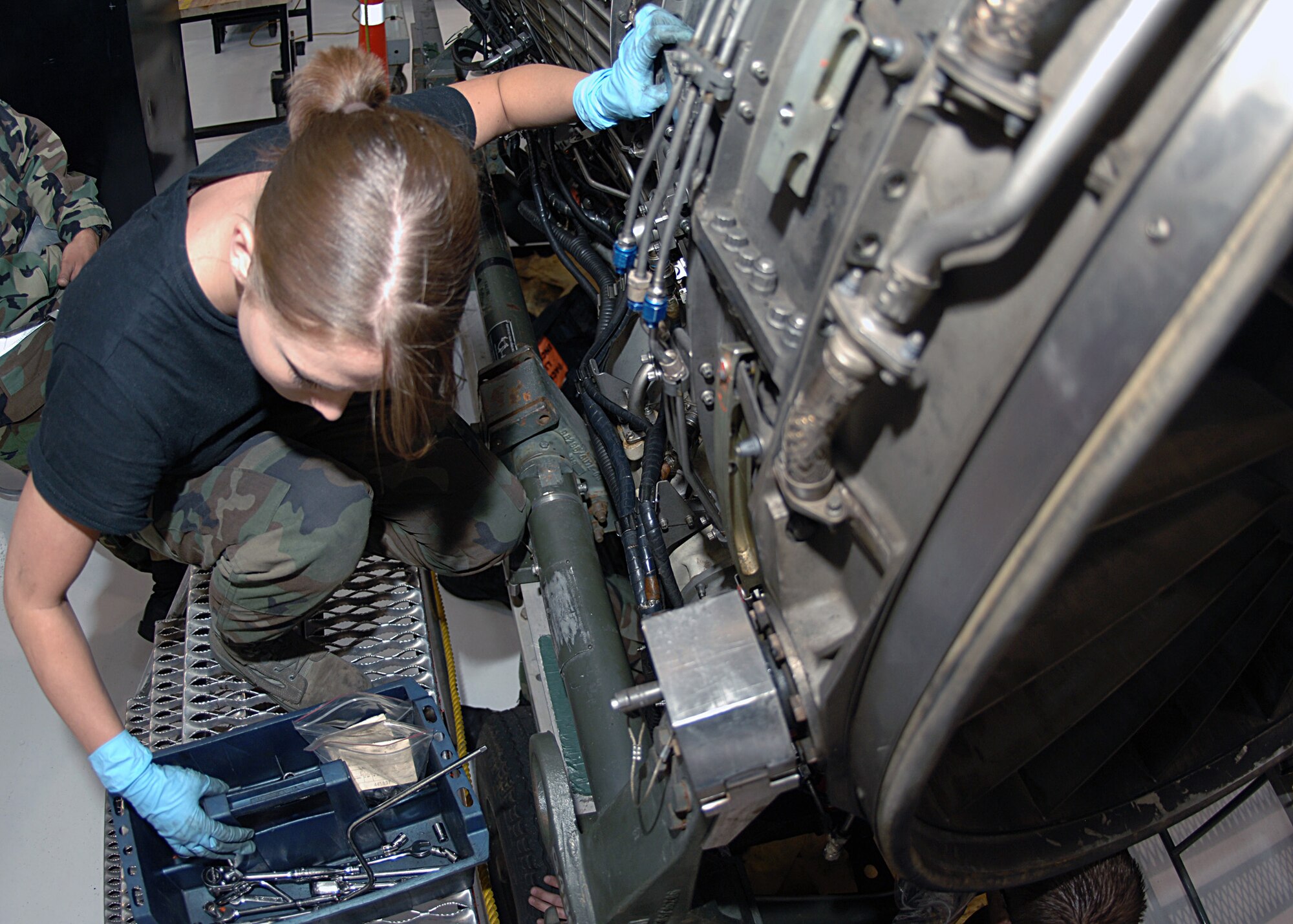 DYESS AIR FORCE BASE, Texas -- Airman 1st Class   Katherine Leas looks in her toolbox for a wrench to take apart a B-1 engine, Mar. 24. The engine disassembly is necessary to find parts that need routine maintenance. (U.S. Air Force Photo by Airman 1st Class Micheal Breaux)  