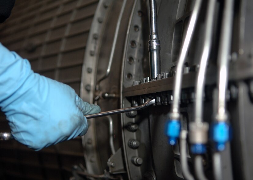 DYESS AIR FORCE BASE, Texas -- Airman 1st Class  Katherine Leas loosens hardware on a B-1 engine during routine maintenance at the engine test center, Mar. 24. The bolts hold the fan casing group together to allow the fan blades to rotate properly. (U.S. Air Force Photo by Airman 1st Class Micheal Breaux)