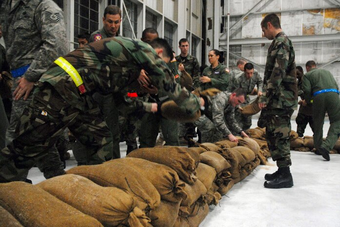 Airmen break down a barrier wall during the Mobility Exercise Crisis Look 08-03 March 20 on the flightline.  Members from the 437th Civil Engineer Squadron taught Airmen how to properly harden a building so it can absorb damage in case of an attack at a deployed location. (U.S. Air Force photo/Staff Sgt. Jennifer Arredondo)