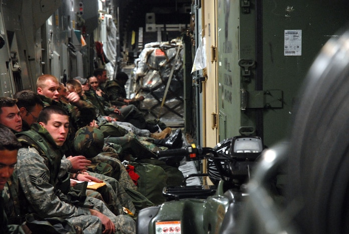 Airmen take a break during the Mobility Exercise Crisis Look 08-03 in a C-17 March 20 on Charleston AFB.  The Airmen were taken to the aircraft to simulate a flight to a deployed location.  After waiting 15 minutes, the Airmen were then taken to a hangar on the flightline for an Ability to Survive and Operate training class. (U.S. Air Force photo/Staff Sgt. Jennifer Arredondo)