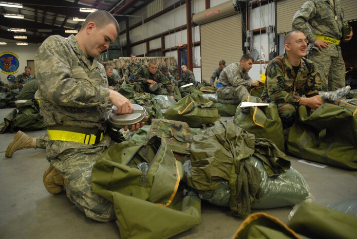 Capt. Christopher Moore inspects his field-gear bag during the Mobility Exercise Crisis Look 08-03 at the 437th Logistics Readiness Squadron Personnel Deployment Facility March 19.  The exercise helped Airmen practice how to mobilize for a deployment for the upcoming Operational Readiness Inspection in August.  Captain Moore is the public affairs officer for the 437th Airlift Wing. (U.S. Air Force photo/Staff Sgt. Jennifer Arredondo)