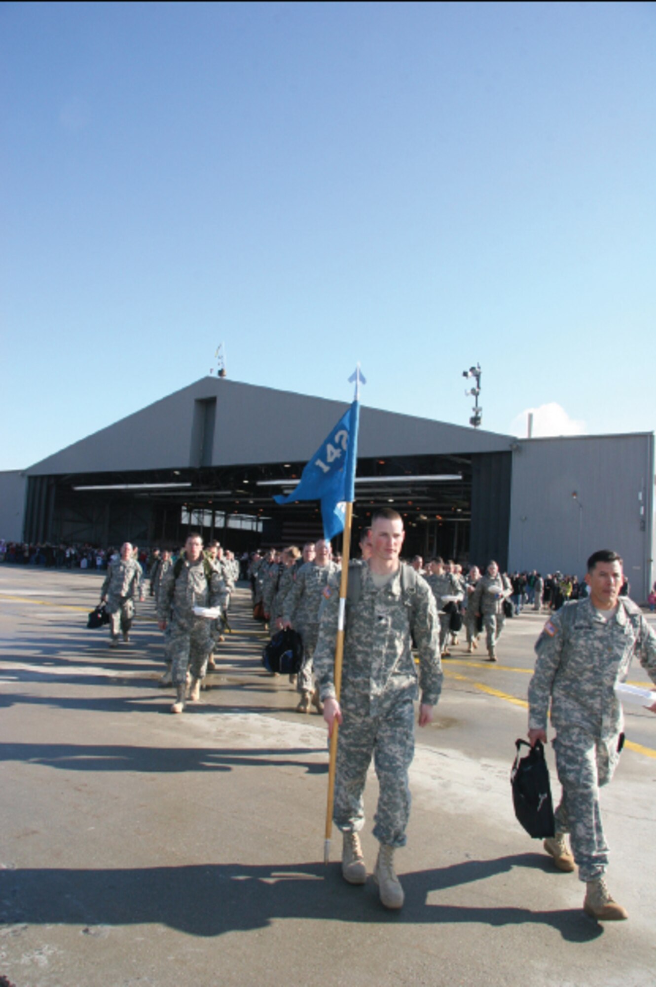 Deploying Soldiers from the 142nd Military Intelligence Battalion leave their families behind at the Utah Air National Guard Base in February. Over 500 soldiers deployed for a year-long mission.