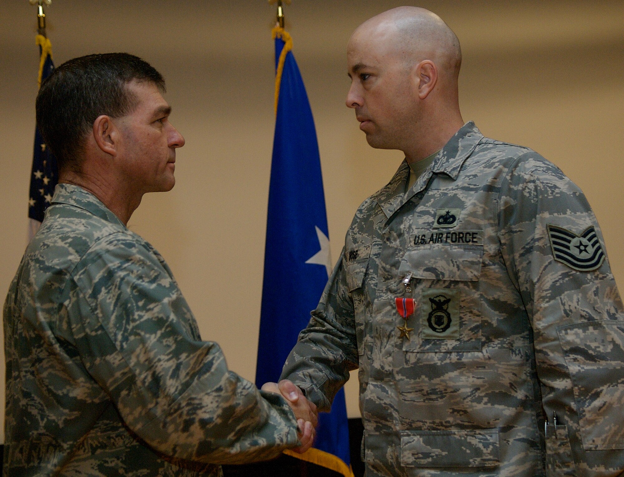 LANGLEY AIR FORCE BASE, Va. – Brig. Gen. Mark Barrett, 1st Fighter Wing commander, congratulates Tech. Sgt. Douglas Rose, 1st Security Forces Squadron, after awarding Sergeant Rose the bronze star medal, first oak leaf cluster, March 25 for his accomplishments while serving with the Joint Task Force in support of Operation Iraqi Freedom from December 2006 to October 2007. Since 2005, the 1st Security Forces Squadron has had six Bronze Stars awarded to members of its unit for dedicated service in Operation Iraqi Freedom. (U.S. Air Force photo/Staff Sgt. Samuel Rogers)