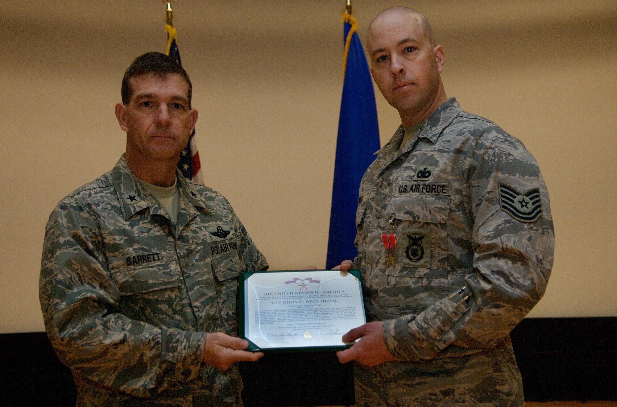 LANGLEY AIR FORCE BASE, Va. -- Brig. Gen. Mark Barrett, 1st Fighter Wing commander, and Tech. Sgt. Douglas Rose, 1st Security Forces Squadron, pause for a photo after the general awarded Sergeant Rose with the Bronze Star Medal, First Oak Leaf Cluster, March 25 for his accomplishments while serving with the Joint Task Force in support of Operation Iraqi Freedom from December 2006 to October 2007. Since 2005, the 1st Security Forces Squadron has had six Bronze Stars awarded to members of its unit for dedicated service in Operation Iraqi Freedom. (U.S. Air Force photo/Staff Sgt. Samuel Rogers)