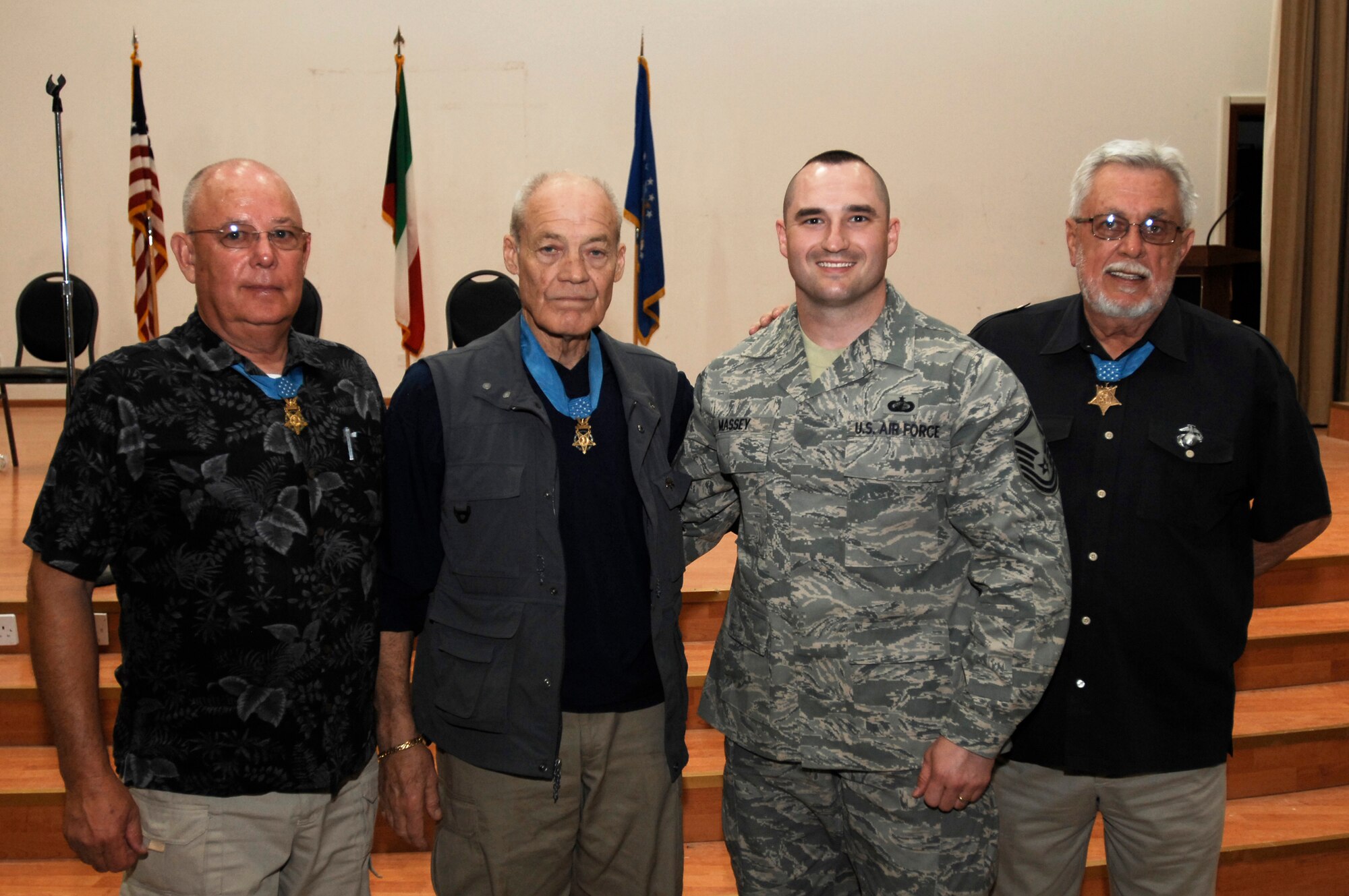 SOUTHWEST ASIA -- Master Sgt. Roy Massey, a member deployed to the 386th Expeditionary Contracting Squadron, takes a group photo with Congressional Medal of Honor recipients March 23, 2008 at an air base in the Persian Gulf Region. Three Congressional Medal of Honor recipients (left to right), Army (retired) Sgt. Maj. Gary Littrell, Army (retired) Col. Robert Howard, and Marine Corps (retired) Capt. John McGinty III are touring throughout the area of responsibility to share their experiences with service members deployed in support of Operations Enduring and Iraqi Freedom. Master Sgt. Massey is deployed from the 62nd Contracting Squadron out of McChord Air Force Base, Wash. (U.S. Air Force photo/ Staff Sgt. Patrick Dixon)