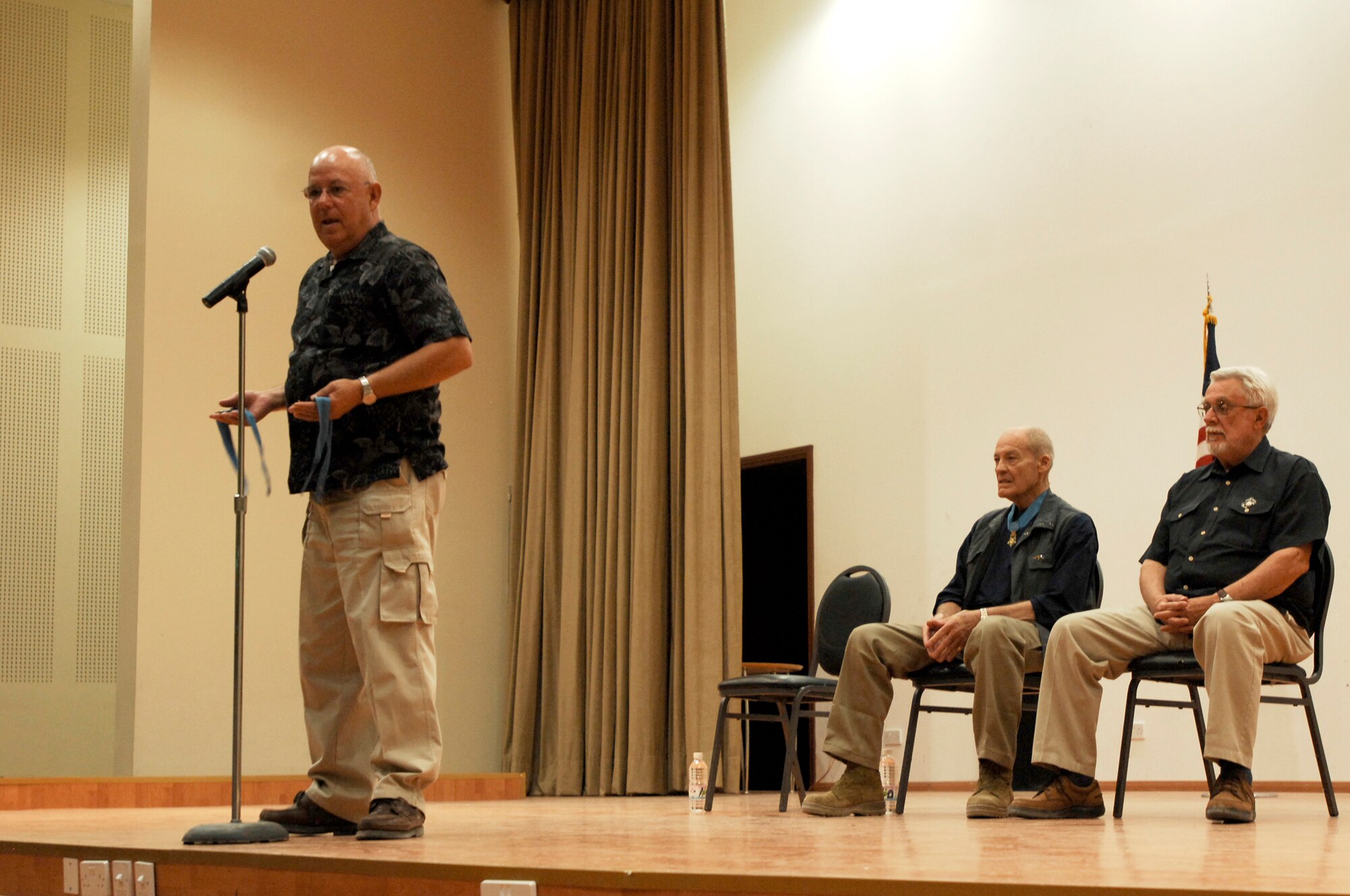 SOUTHWEST ASIA -- Congressional Medal of Honor recipient Army (retired) Sgt. Maj. Gary Littrell speaks to Airmen, Soldiers and Marines about the history behind each services respective medal at the 386th Air Expeditionary Wing theater March 23, 2008, at an air base in the Persian Gulf Region. Three Congressional Medal of Honor recipients, Colonel Robert Howard, Marine Corps (retired) Capt. John McGinty III, and Army (retired) Sgt. Maj. Gary Littrell, are touring throughout the area of responsibility to share their experiences with service members deployed in support of Operations Enduring and Iraqi Freedom. Today, only 105 recipients are still alive.  (U.S. Air Force photo/ Staff Sgt. Patrick Dixon)