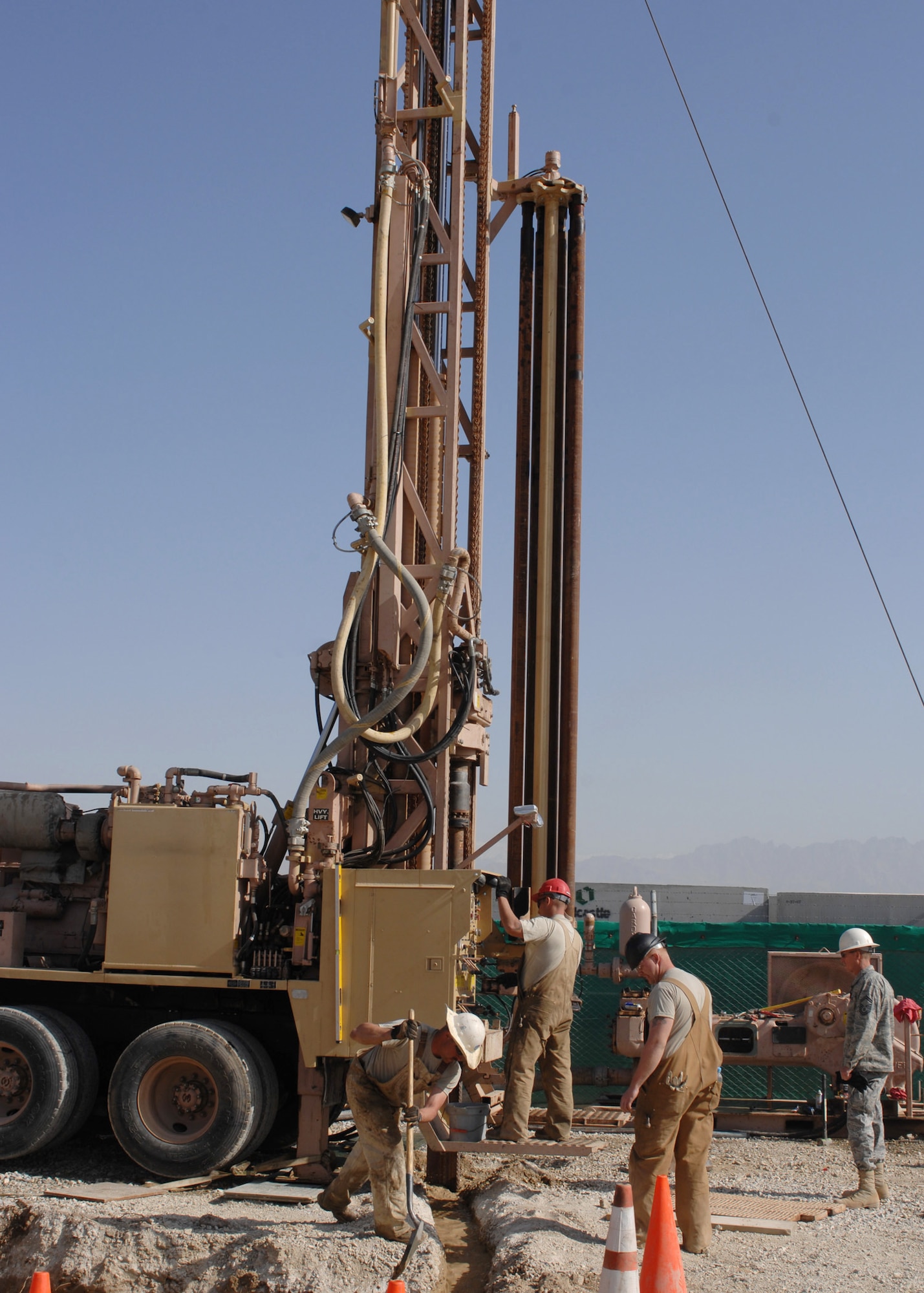 BAGRAM AIR BASE, Afghanistan –Airmen from the 819th RED HORSE Squadron drill a test hole to operationally check a water-well digging rig here March 21.  More than $400,000 of damage to the rig was repaired at a cost of $80. (U.S. Air Force photo by Master Sgt. Demetrius Lester)