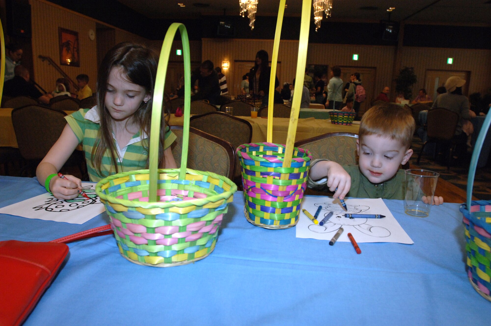 MISAWA AIR BASE, Japan -- Emma and Soren Larsen, ages 6 and 3 years old, color pictures at an Easter egg hunt in the officer's club March 23, 2008.  The event offered coloring books and treats along with the opportunity to hunt for Easter eggs.  (U.S. Air Force photo by Senior Airman Robert Barnett)