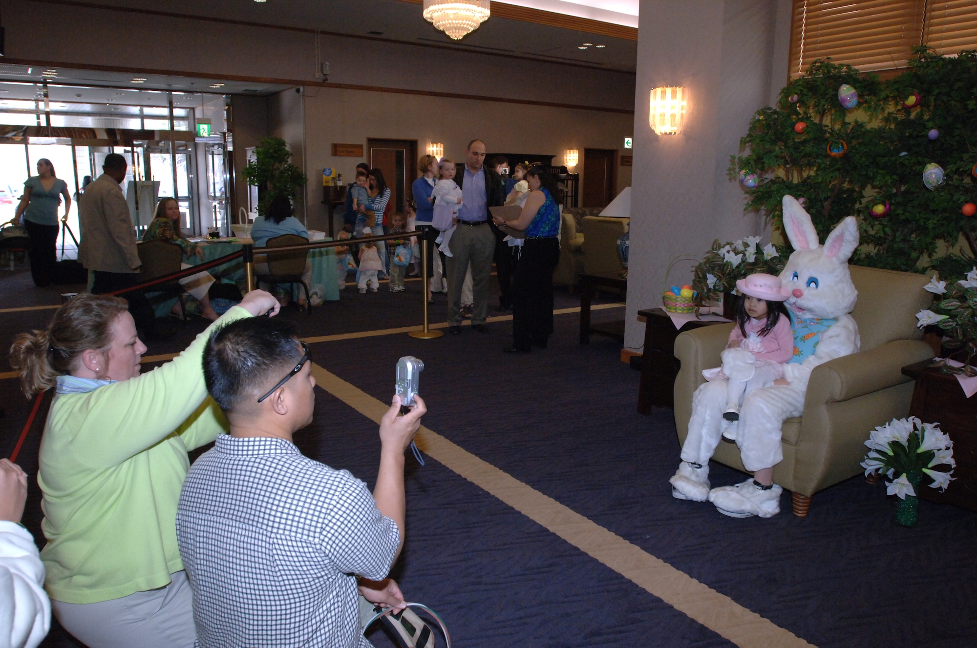MISAWA AIR BASE, Japan -- Families take portaits with the Easter bunny during the Easter Egg Hunt at the Officer's Club March 23, 2008.  The Easter egg hunt was available for free to club members.  (U.S. Air Force photo by Senior Airman Robert Barnett)