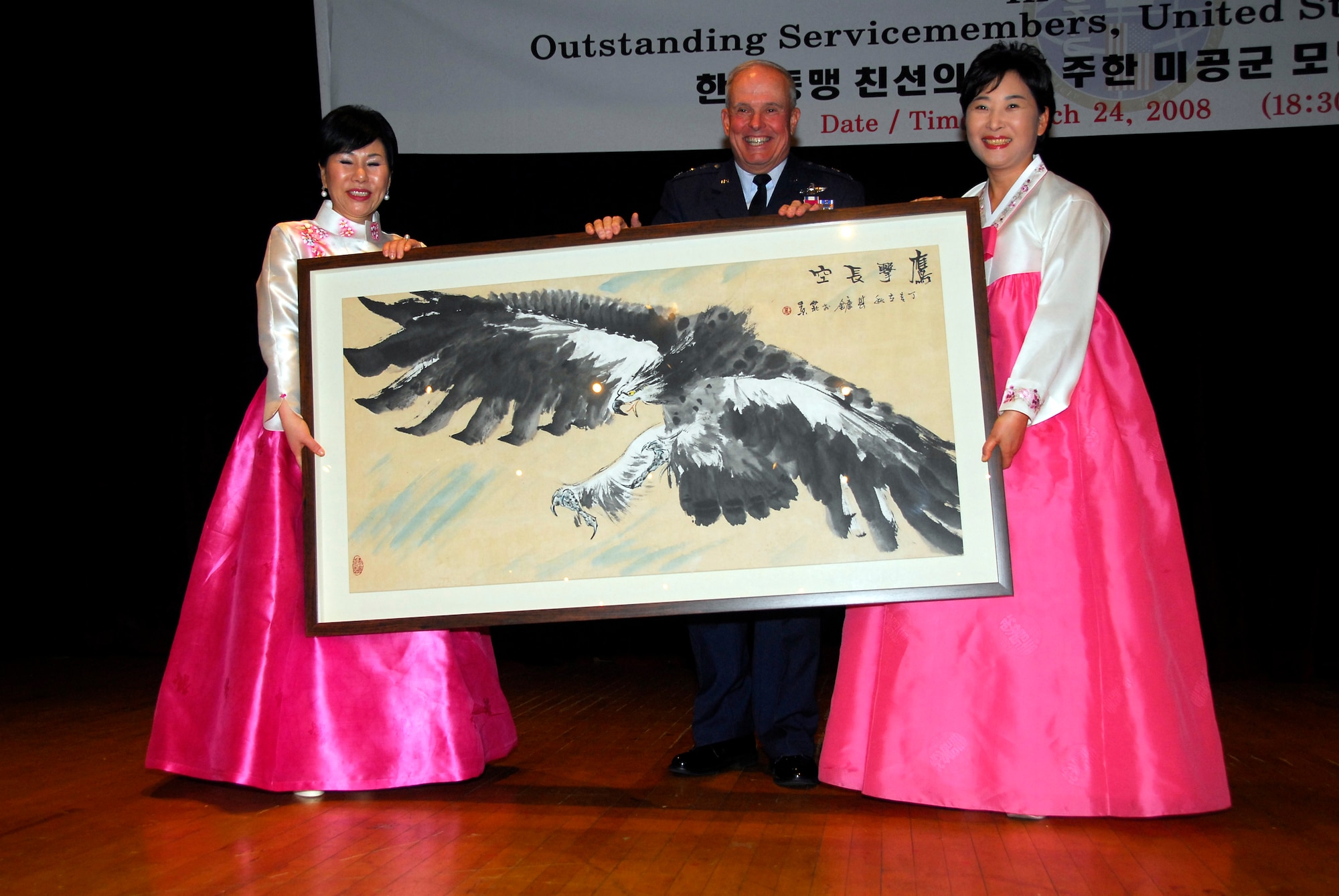 OSAN AIR BASE, Republic of Korea--The destiny for Seventh Air Force Commander Lt. Gen. Stephen G. Wood (center) became more vivid, as a pro-American Korean group bestowed upon him a Korean name. Witnessed by the Chief Master Sergeant of the Air Force Rodney J. McKinley and approximately 200 Airmen, Soldiers, Sailors, and Marines and ROK civic leaders, Chairman Suh Jin Sup of the Korea-U.S. Alliance Friendship Society gave General Wood the name “Woo, Chang Hui.” (Pronounced Woo, Chang Hee).  (U.S. Air Force photo/Senior Airman Christopher Boitz)