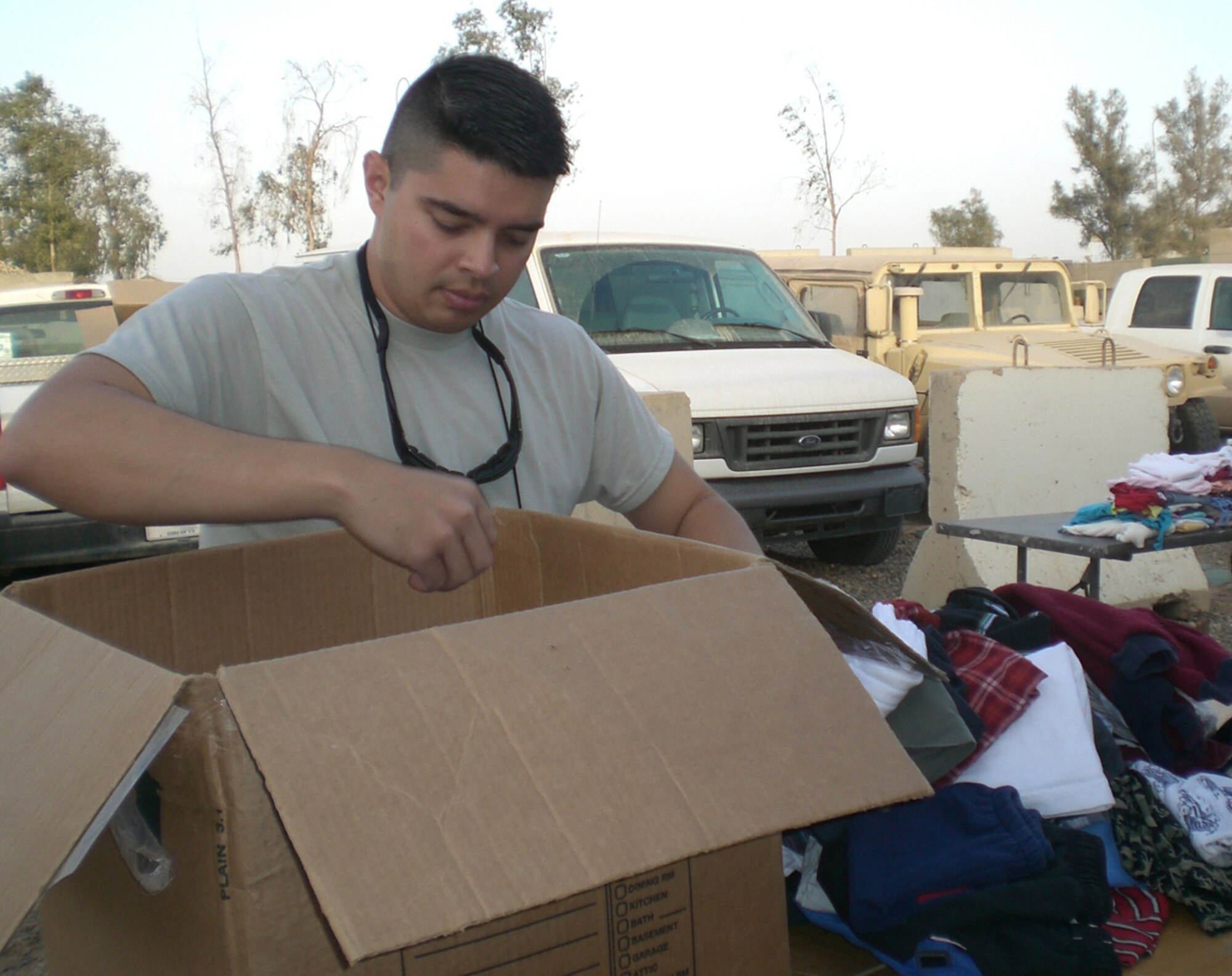 BALAD AIR BASE, Iraq -- Capt. Patrick Smyth, 727th Expeditionary Air Control Squadron "Kingpin" company grade officer, sorts items donated by Balad personnel for distribution to the local Iraqi people who live near Balad Air Base. Since February 2008, base personnel have collected more than 15,000 items weighing more than 3,000 pounds for distribution to the local population. Captain Smyth is deployed from the 728th Air Control Squadron, Eglin Air Force Base, Fla. (U.S. Air Force courtesy photo)