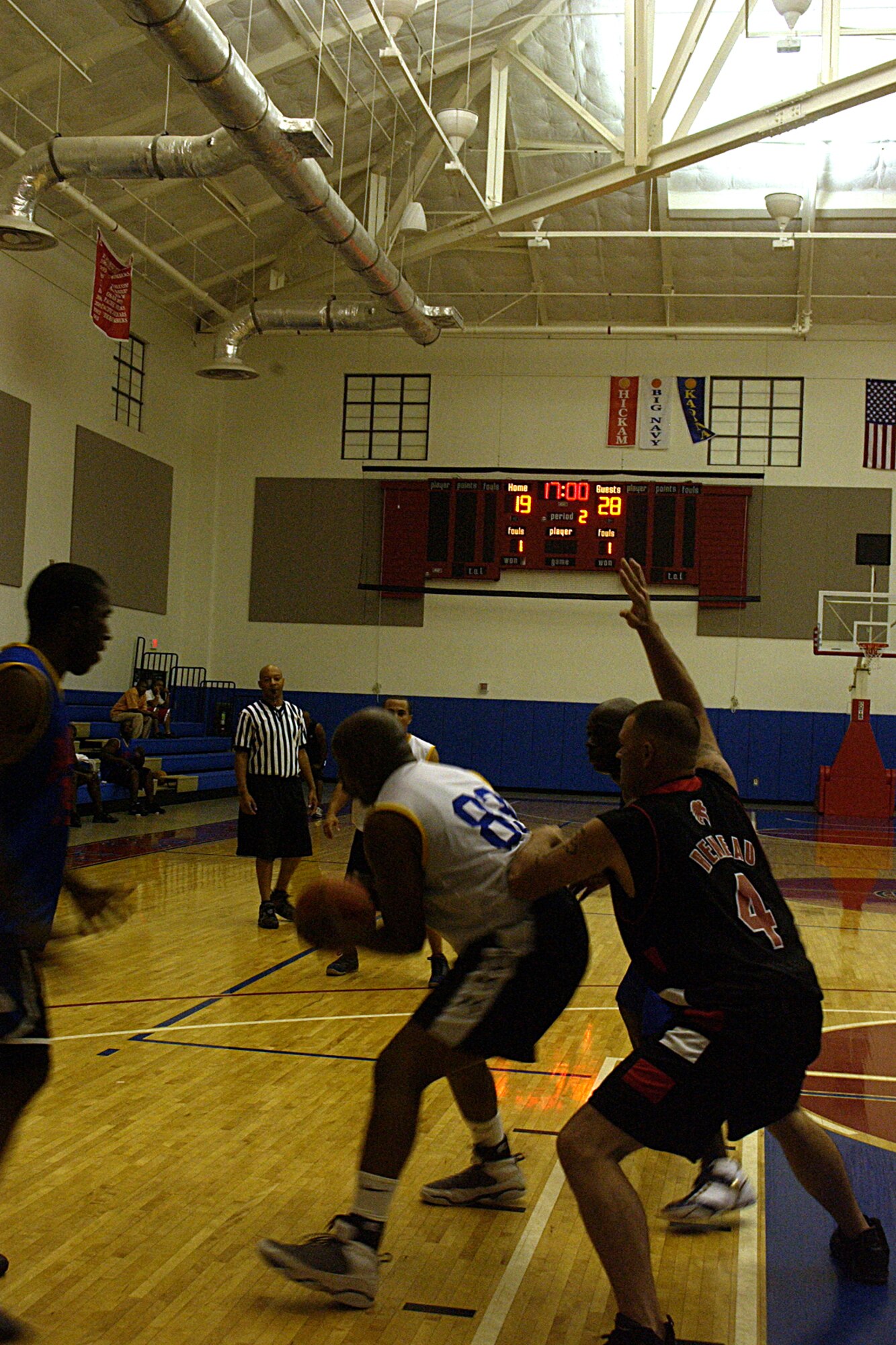 Staff Sergeant Patrick Mitchell, 36th Wing Public Affairs looks for another player to pass the ball to as Staff Sergeant Jeremy Reneau, 554 REDHORSE Squadron guards him during the championship game of the intramural basketball league here at Andersen.  (U.S. Air Force photo by Airman 1st Class Carissa Wolff) 