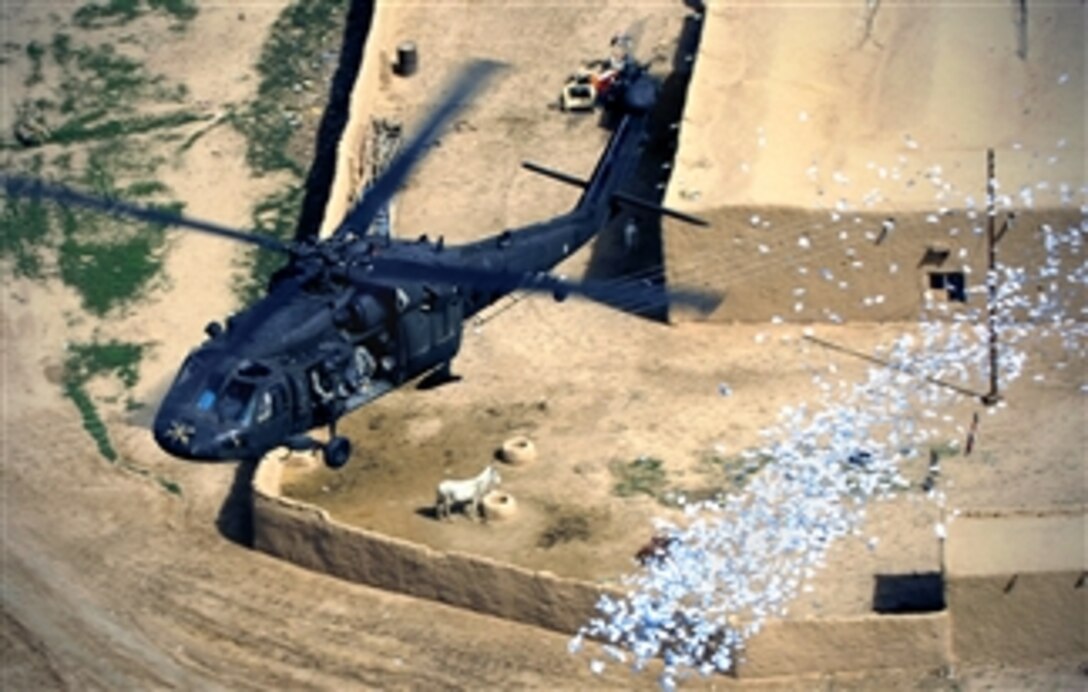U.S. Army soldiers drop leaflets over several villages in the Rashaad Valley near the Kirkuk province of Iraq, March 23, 2008. The soldiers are assigned to the 10th Mountain Division's 350th Tactical Psychological Operations.