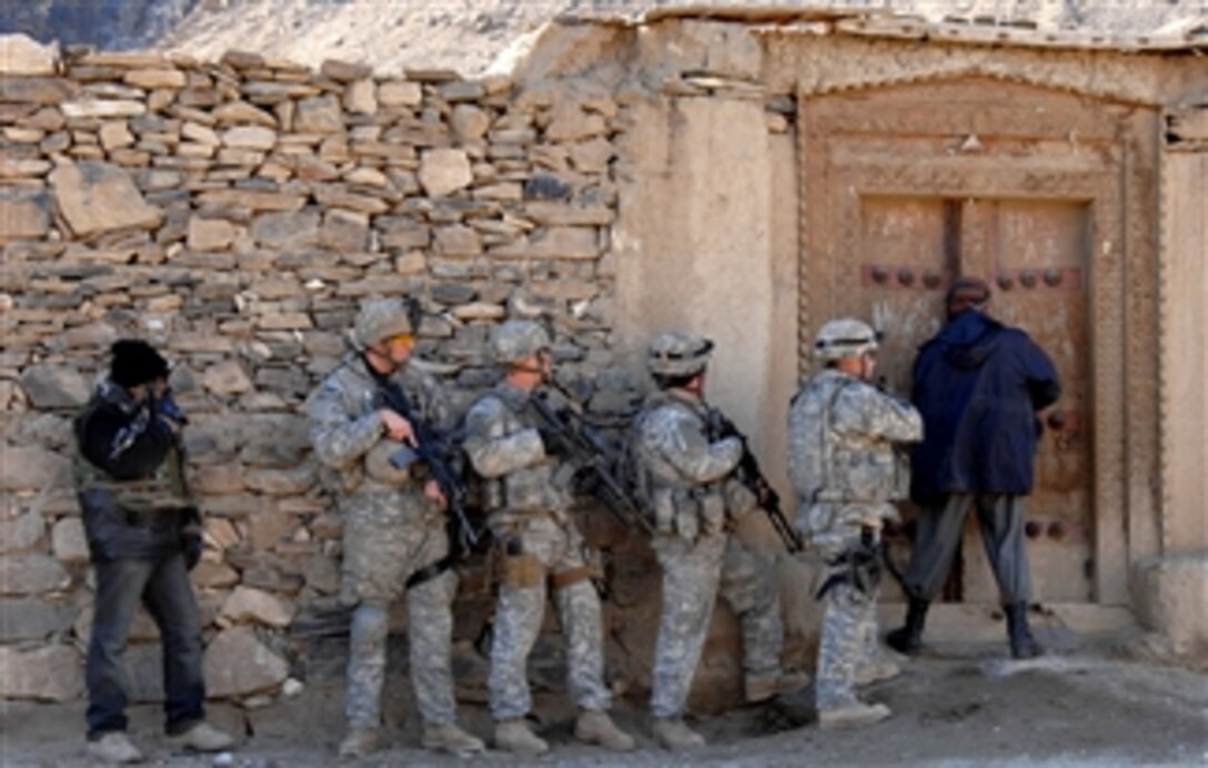 U.S. Army soldiers prepare to enter a house along Main Supply Route Vermont in the Tagab district, Kapisa province, Afghanistan, Jan. 18, 2008. The soldiers are assigned to the 82nd Airborne Division's Company B, Special Troops Battalion, Task Force Gladius.