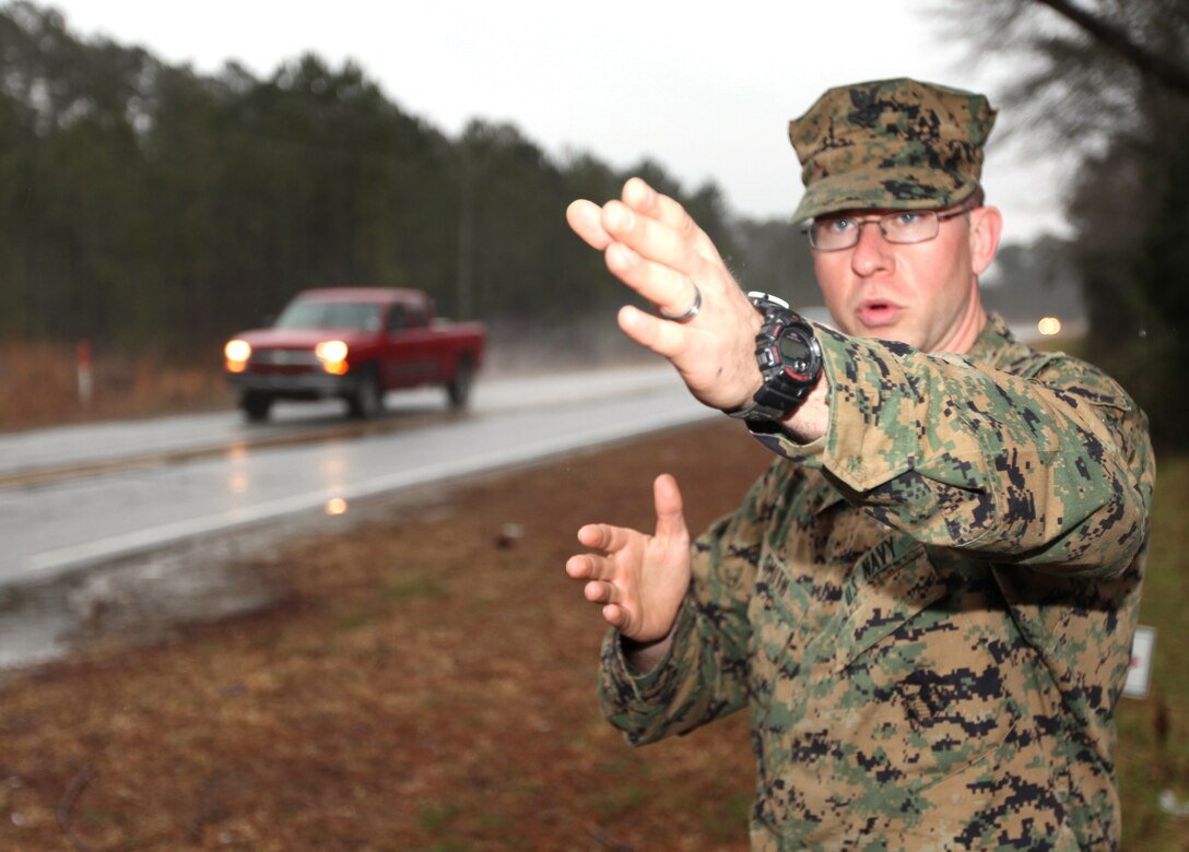 Petty Officer 2nd Class Jason B. Smith, a corpsman with II Marine Expeditionary Force Special Operations Training Group, describes a three-car accident on U.S. Highway 210 where a pickup truck rear ended a small sedan, Jan. 27, 2010.  Smith and a fellow SOTG corpsman, Petty Officer 1st Class Jesus F. Santiago, pulled a woman from one of the vehicles involved in the accident as flames engulfed her vehicle. (U.S. Marine Corps photo by Staff Sgt. Jayson Price)