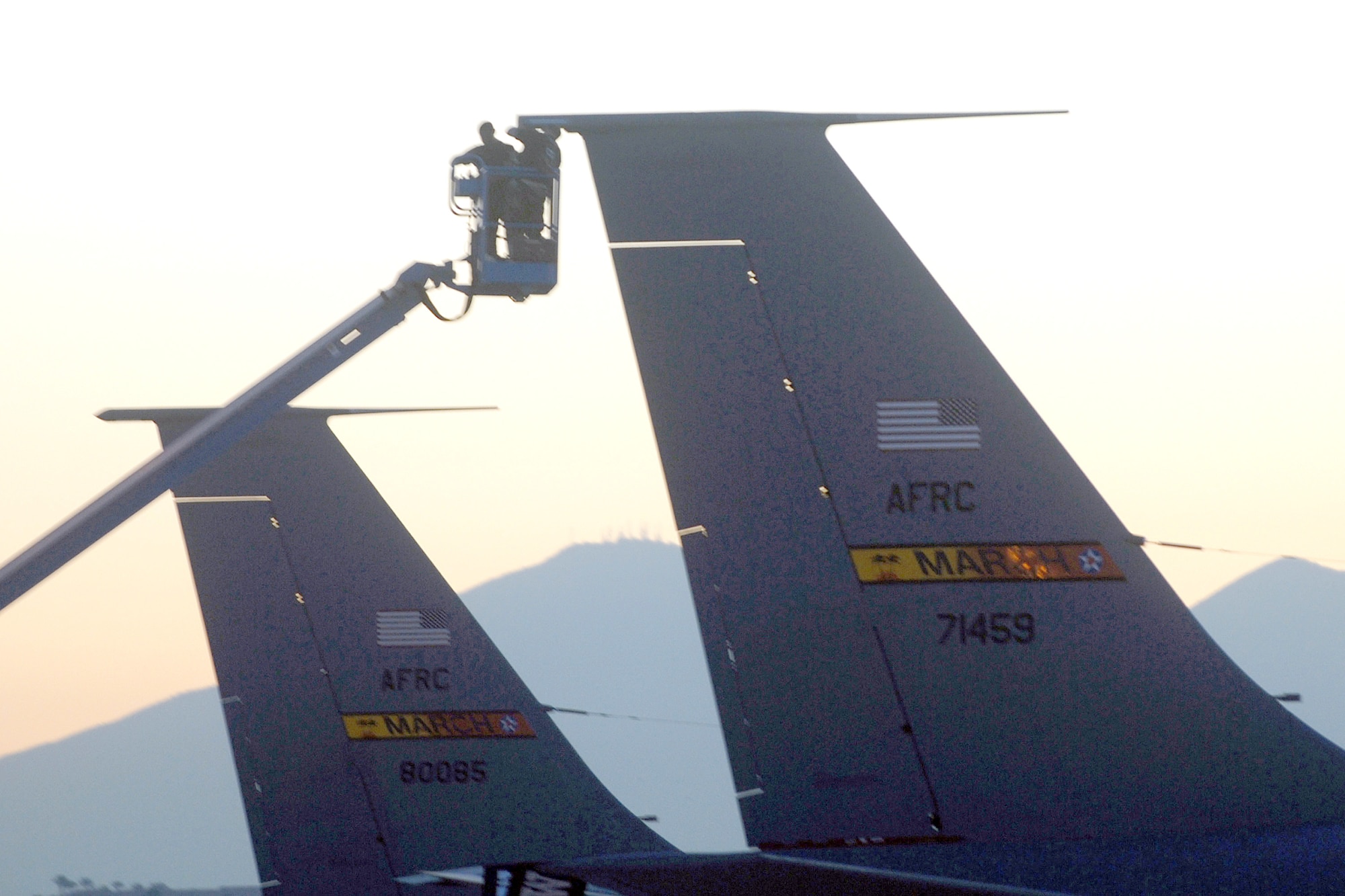 Mechanics from the 452nd Air Mobility Wing use a cherry picker to check the tail of a KC-135 Stratotanker refueling aircraft from the 336th Air Refueling Squadron during an inspection at March Air Reserve Base, Calif. (U.S. Air Force photo by Val Gempis)